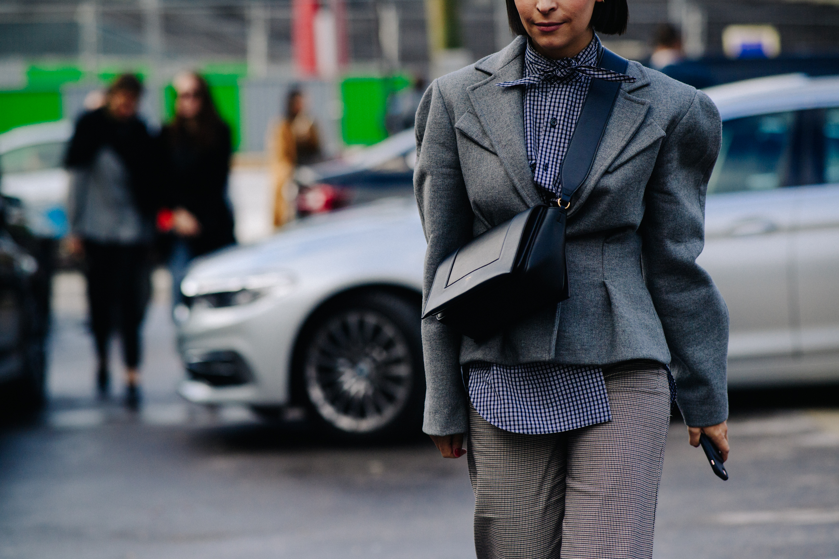 Woman wearing grey blazer and hanbag