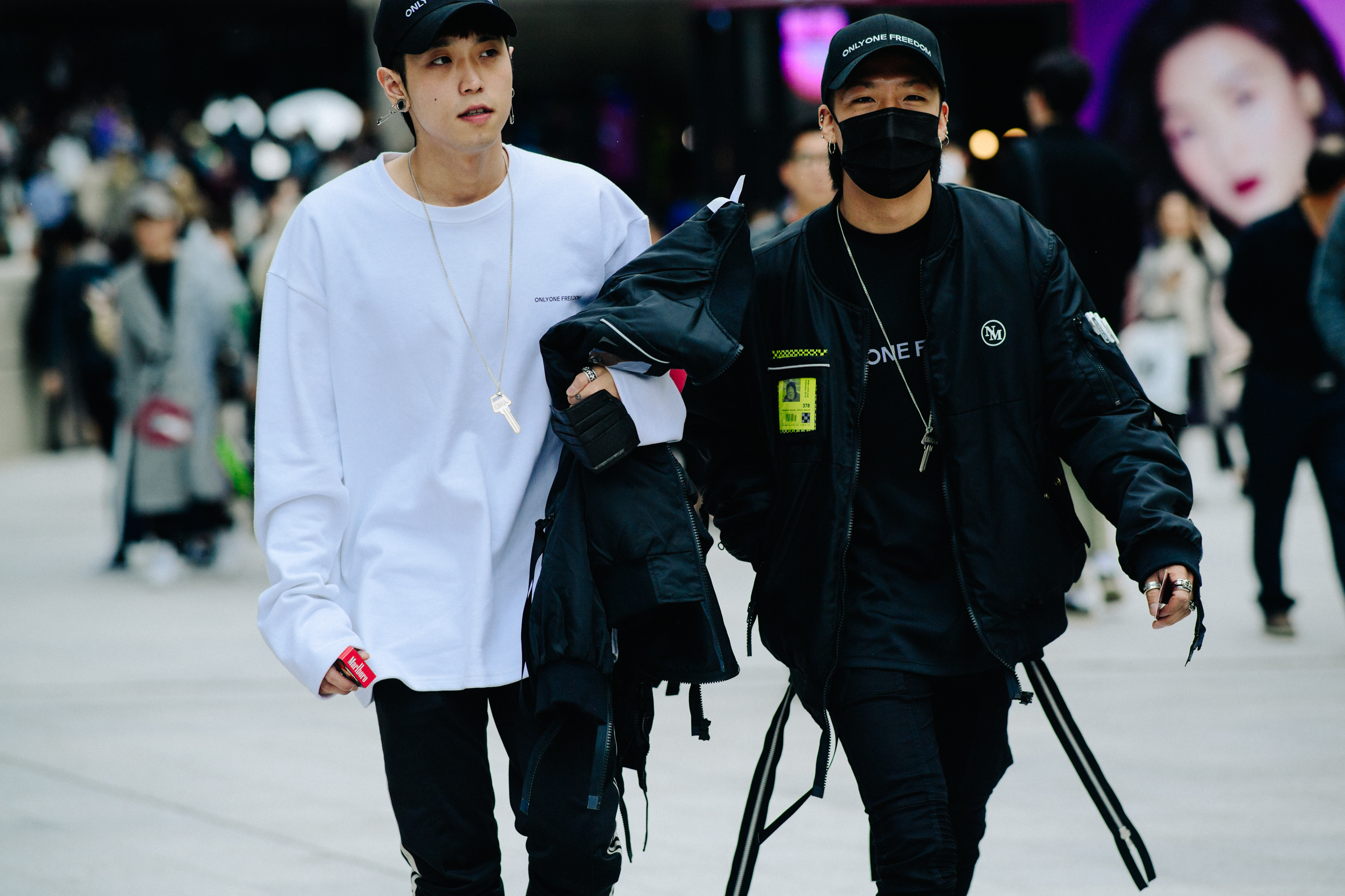 Two men wearing black bomber jackets with zips
