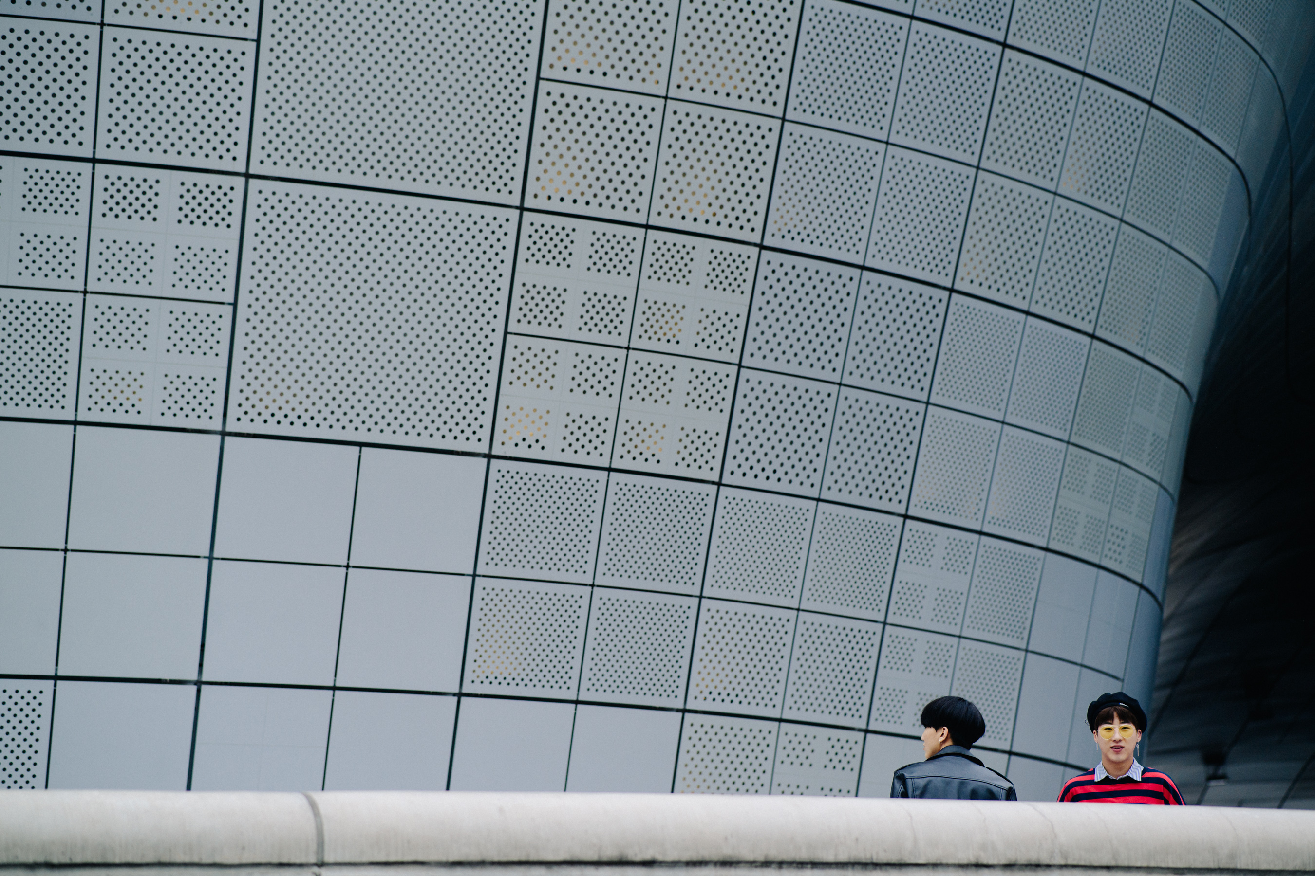 Detail of metal building in Seoul with two men