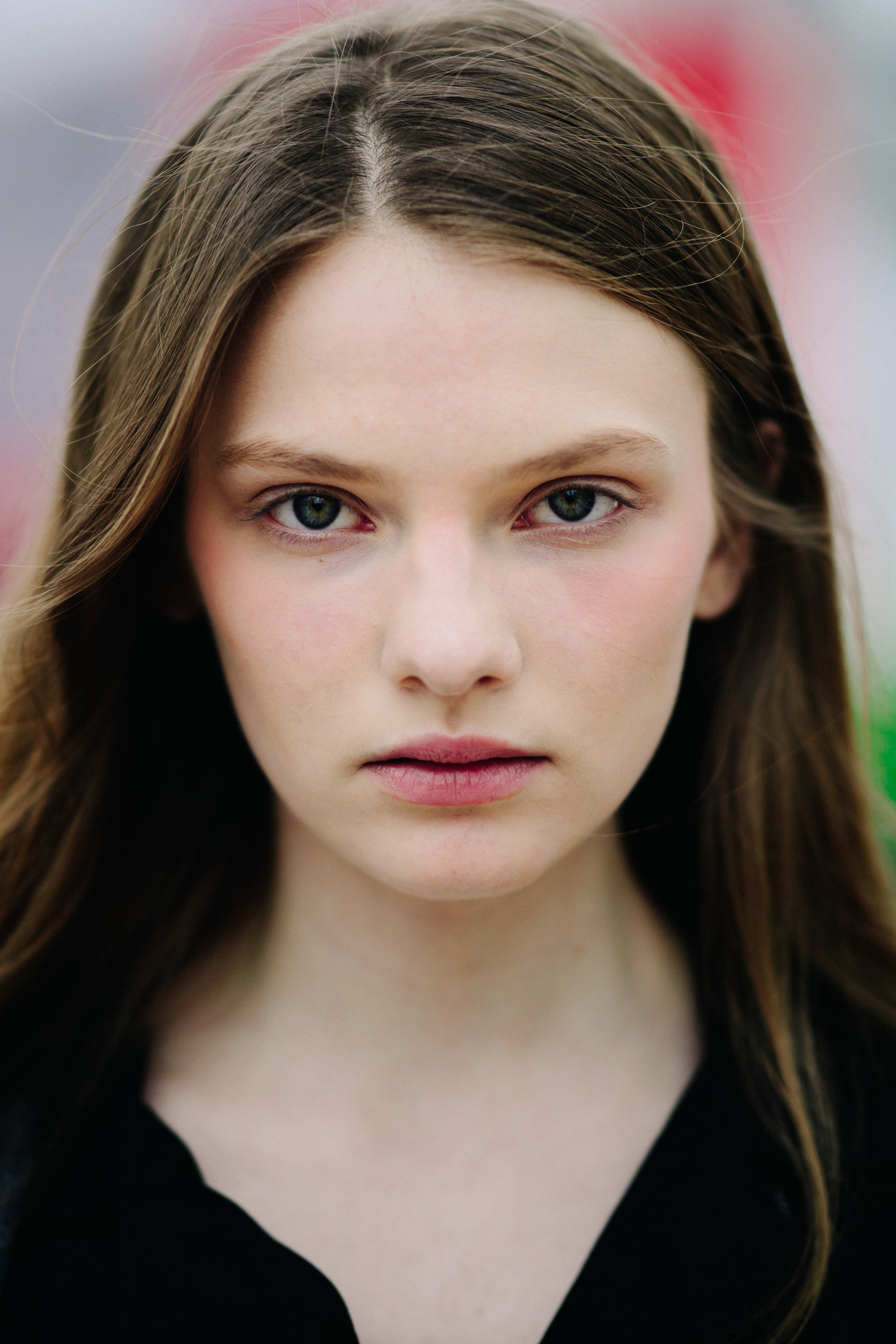 Portrait of model with long brown hair and green eyes
