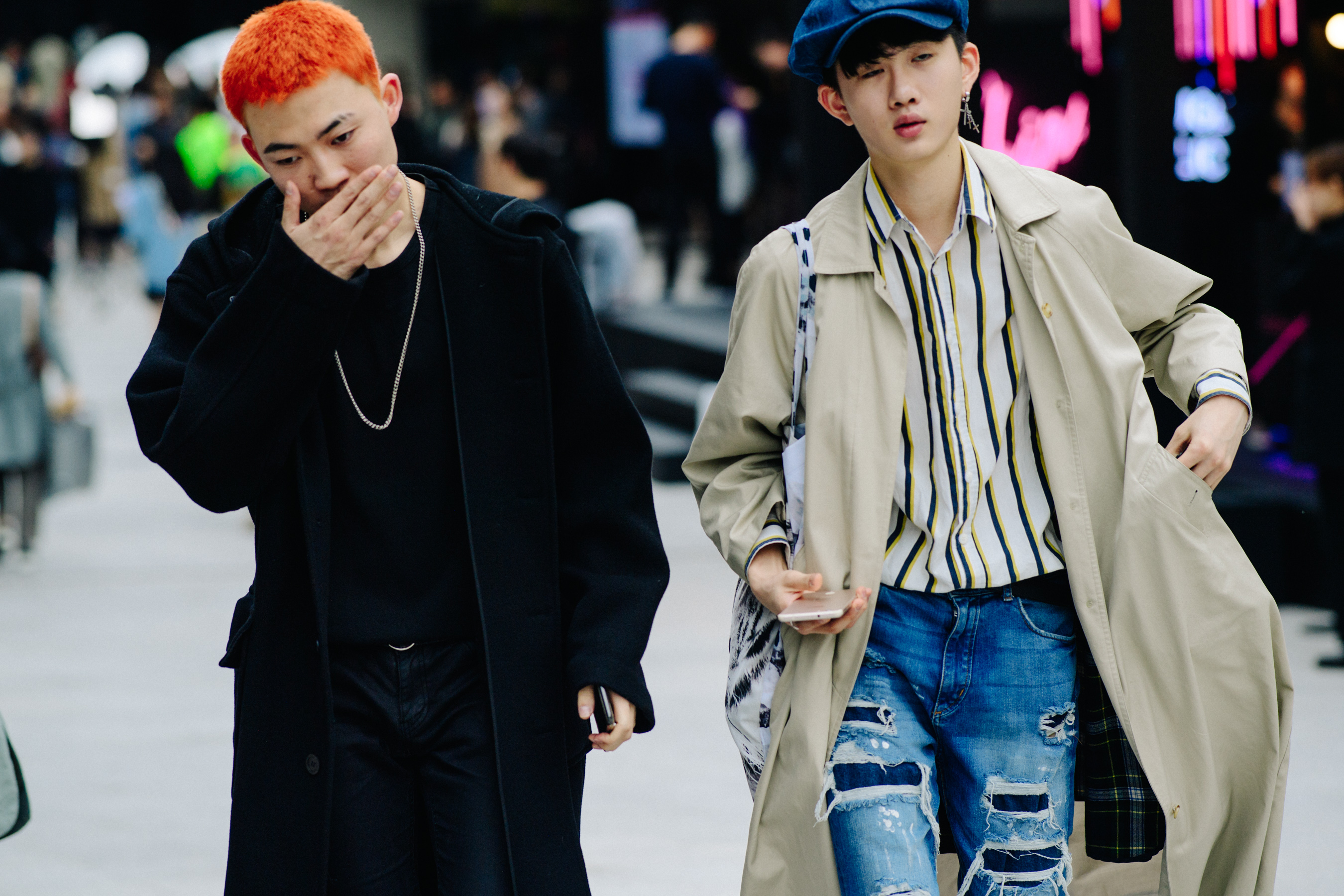 Two men wearing winter coats and denim jeans
