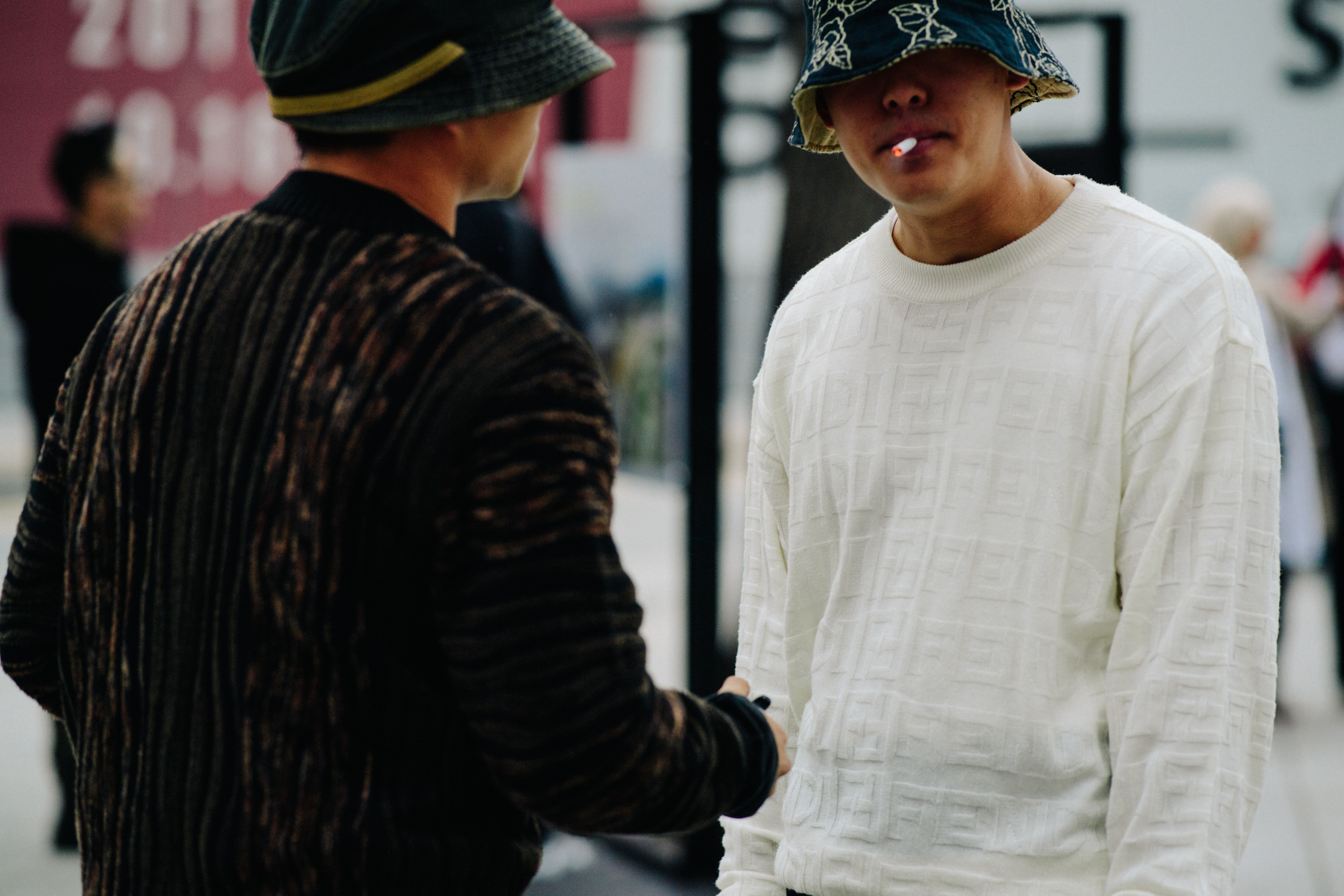 Man smoking in bucket hat