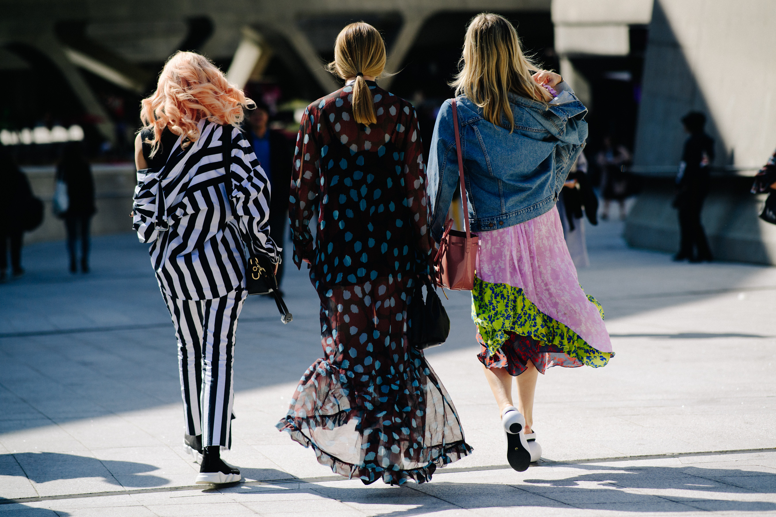 Back of three women in patternered outfits