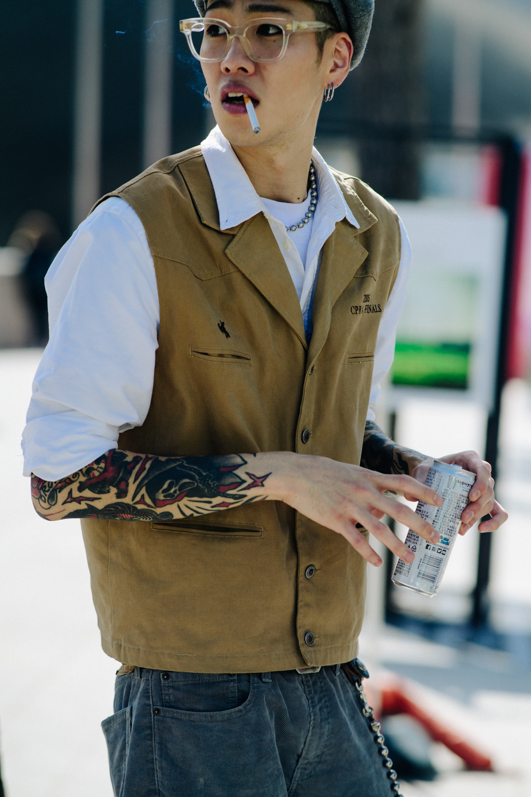 Crop of man in camel waistcoat and white shirt