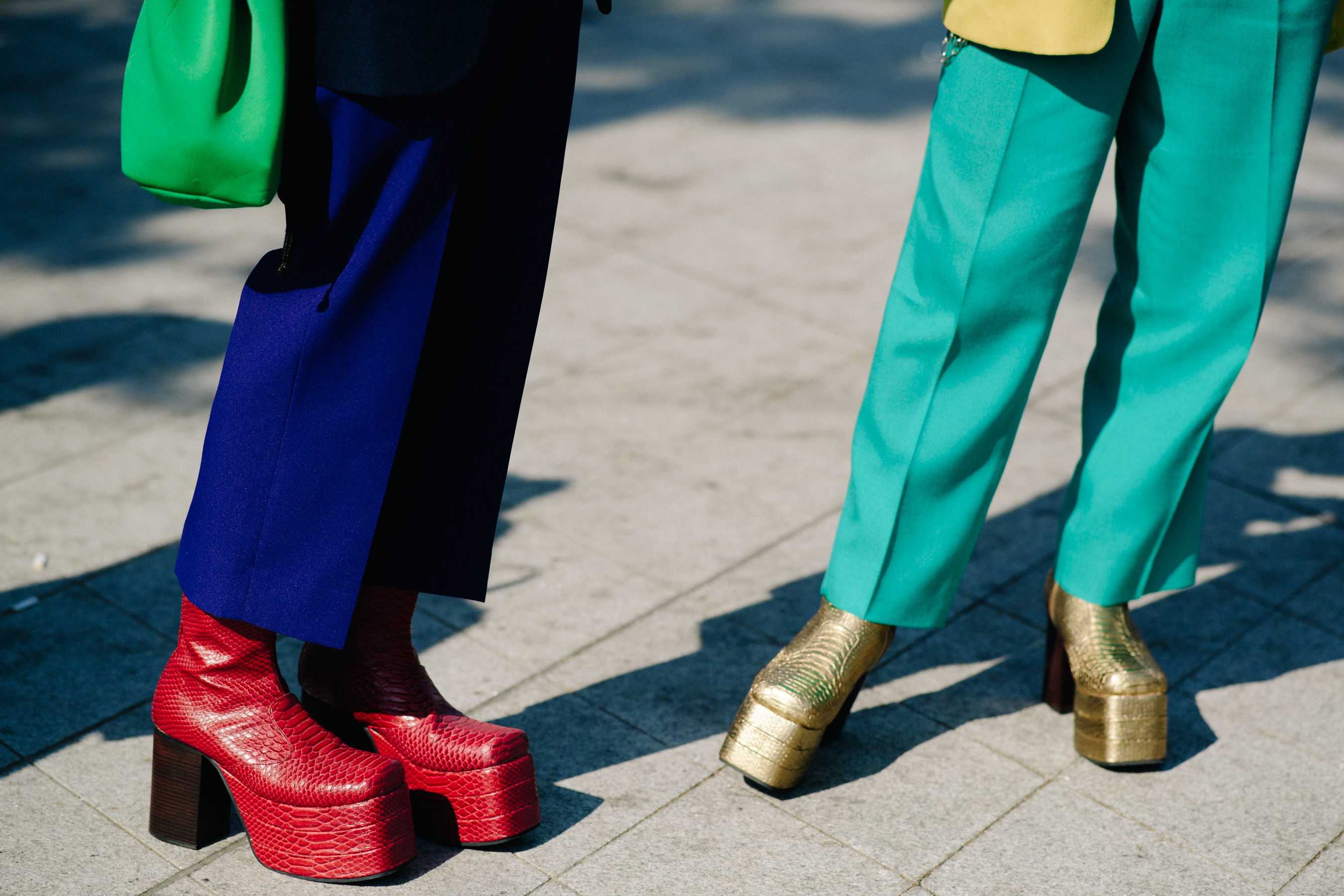 Closeup of gold and red heeled boots