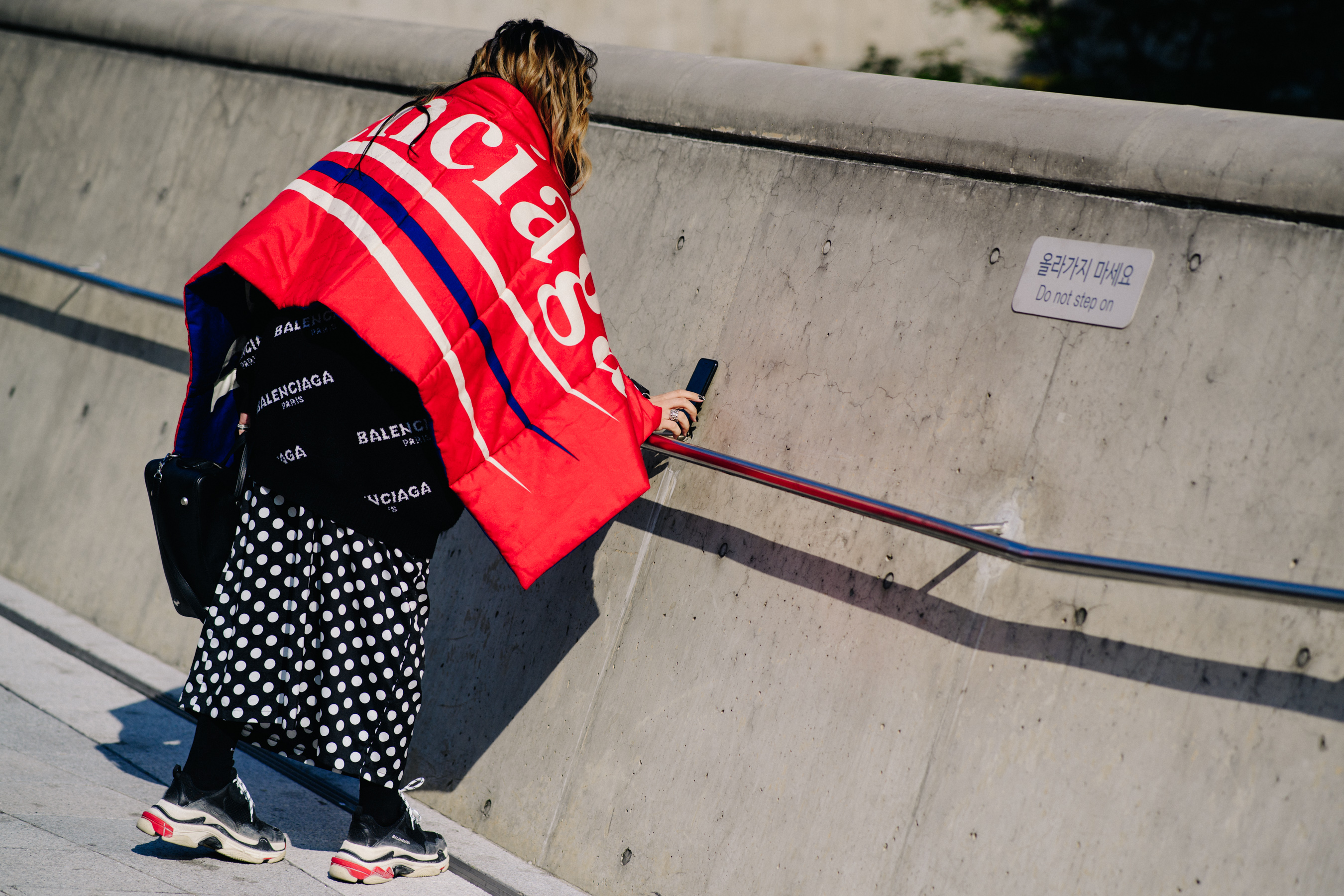 Woman wearing red Balenciaga blanket