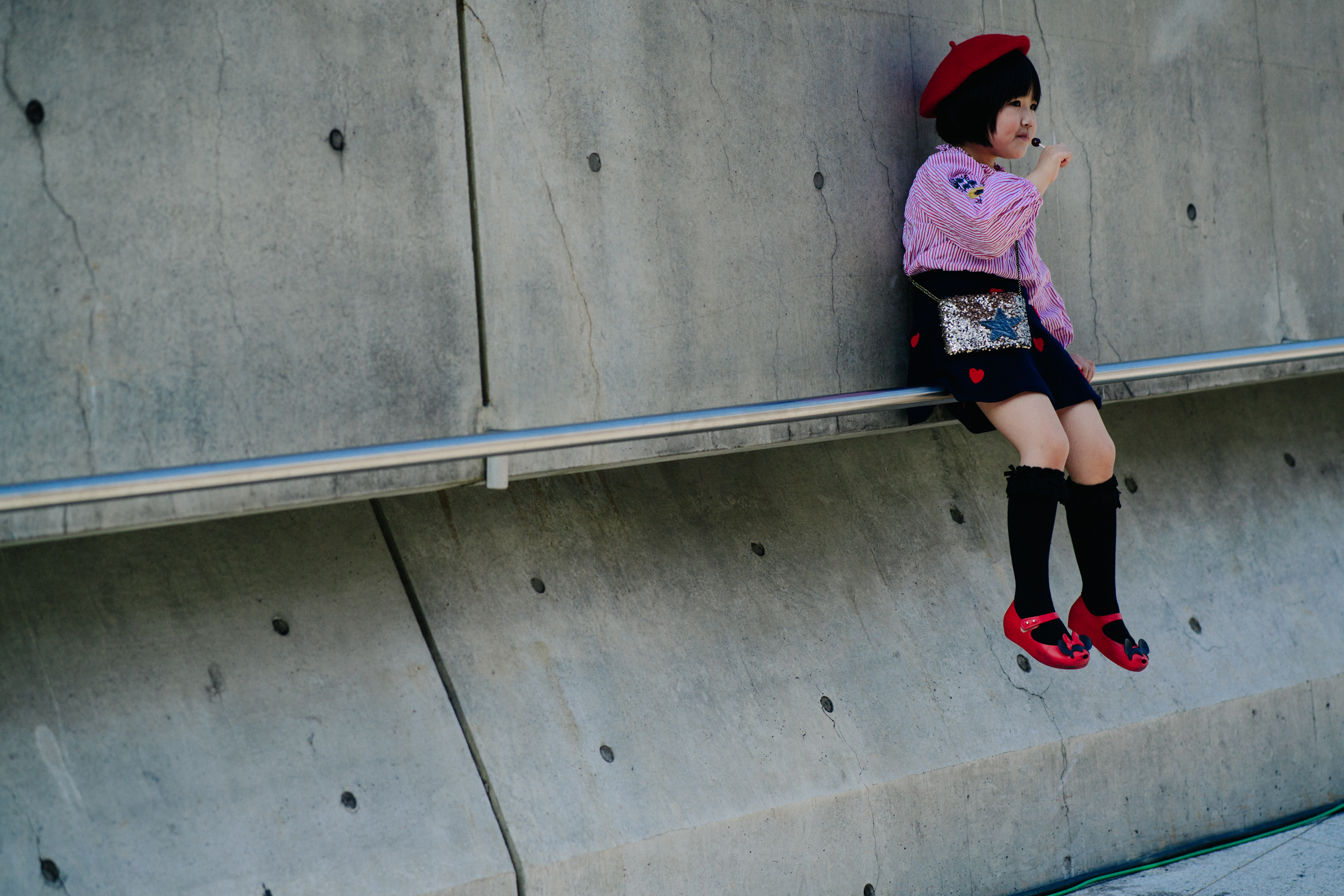 Korean child with lollipop in red beret