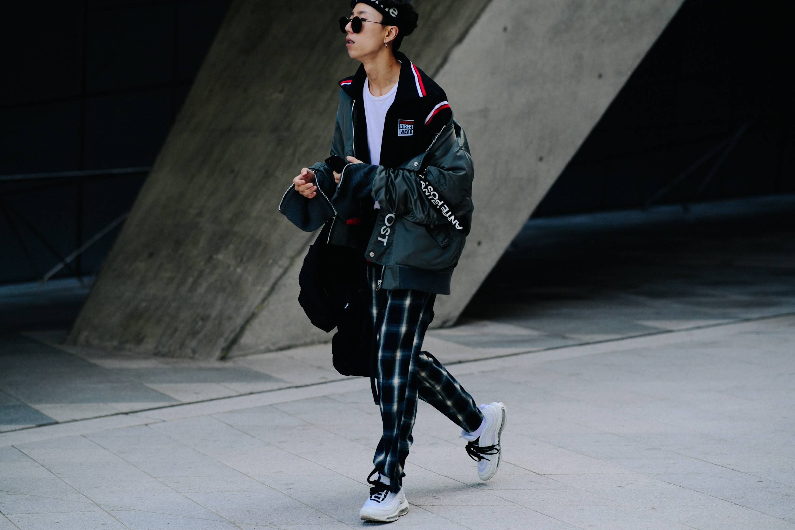 Man in black jacket and white sneakers