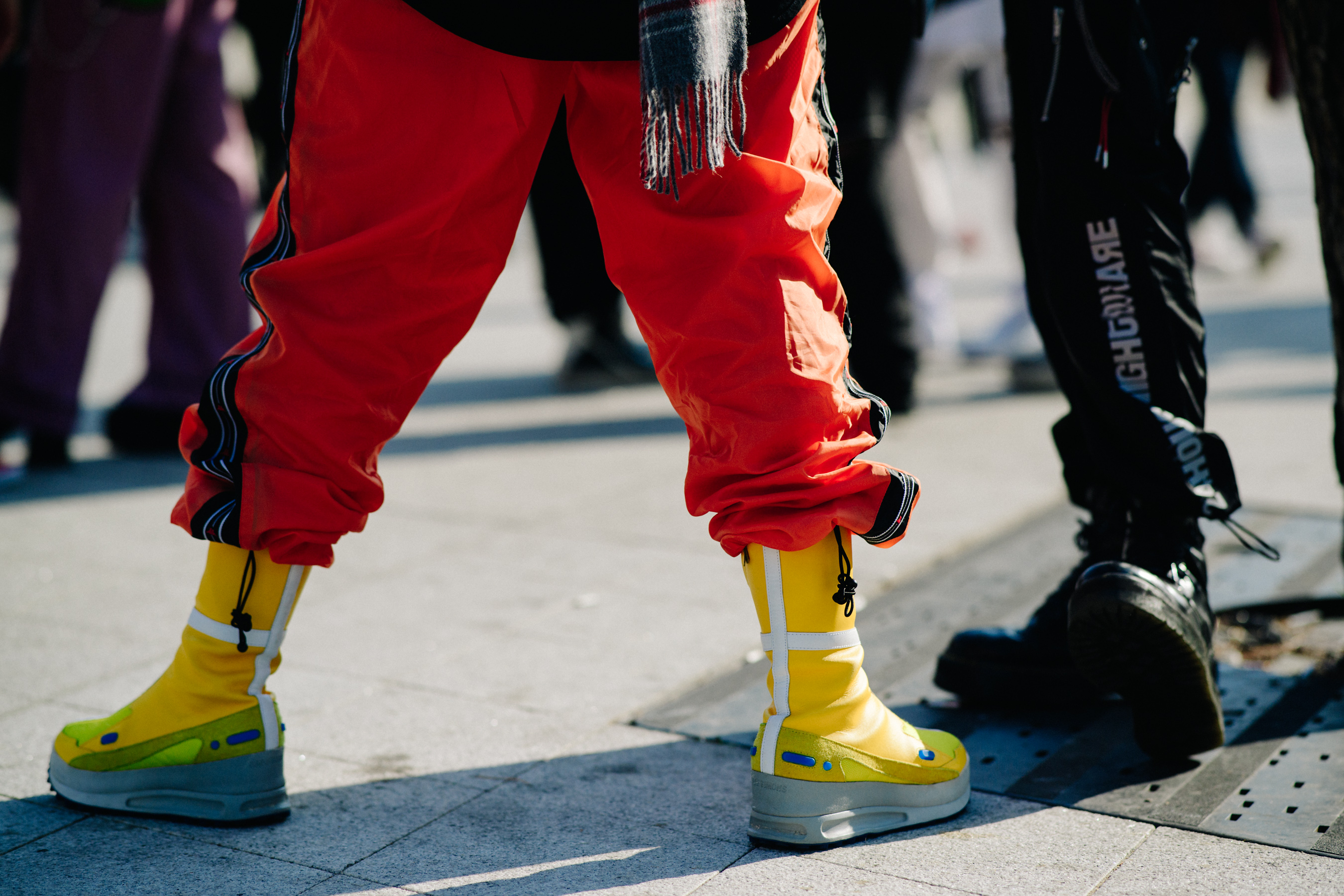 Closeup of man in yellow boots with orange pants