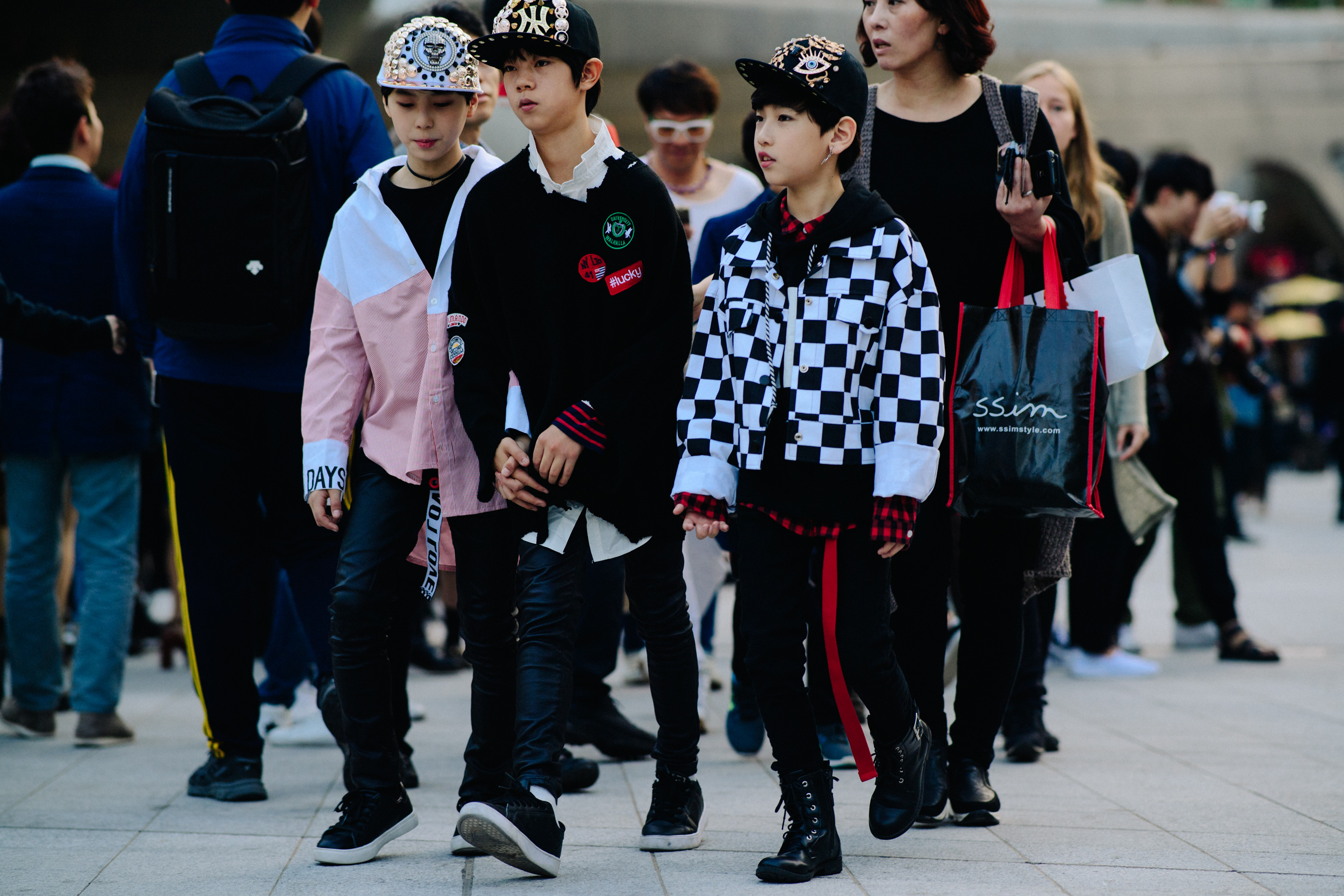 Group of children in black caps and leather pants