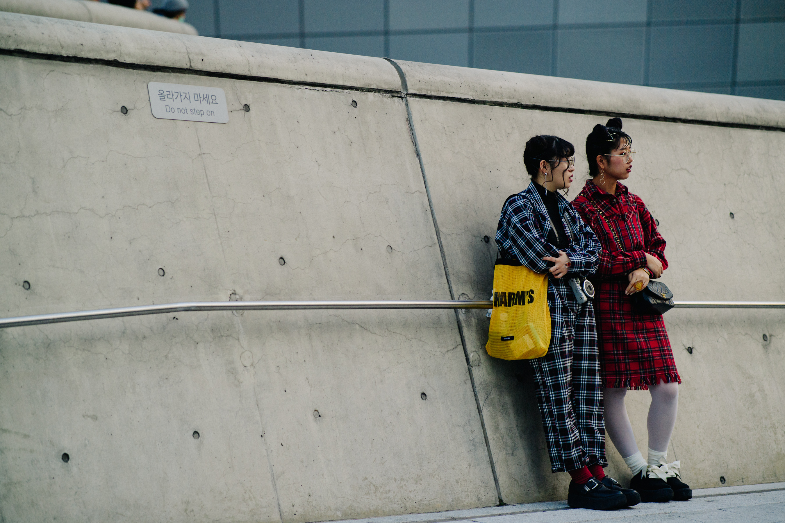 Two women wearing black and red check outfits