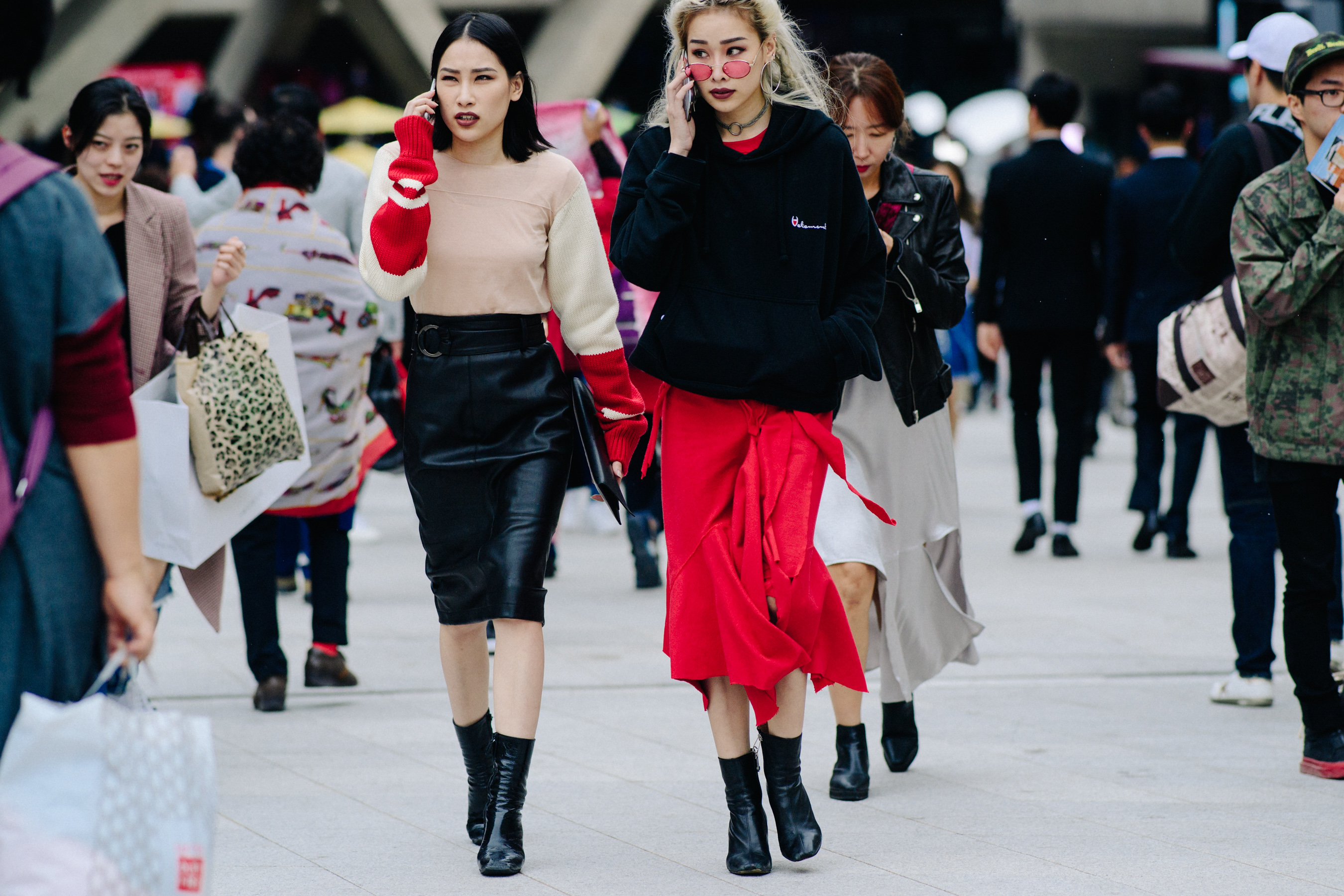 Two women walking in red and black outfits