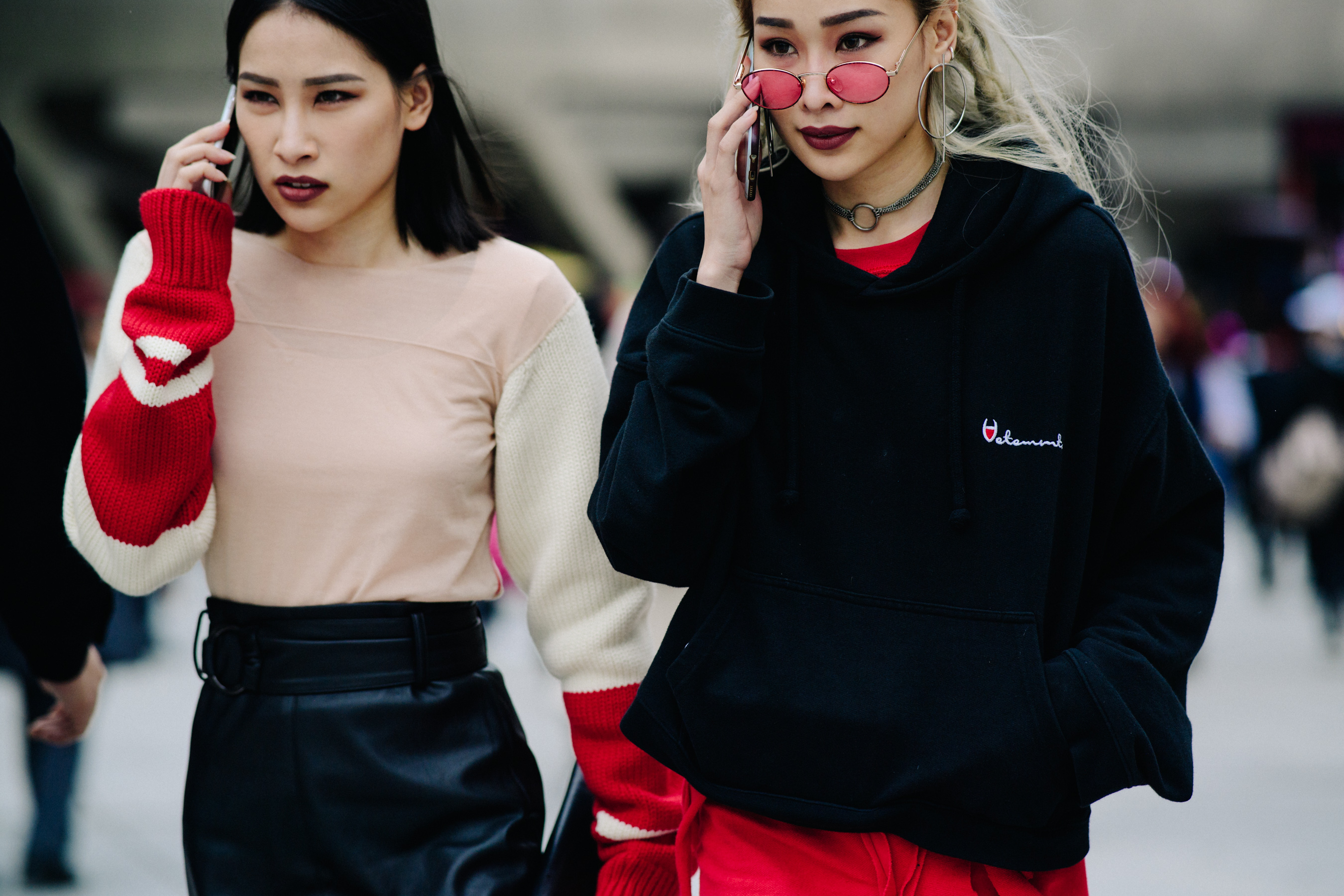 Crop of two women in red and black outfits