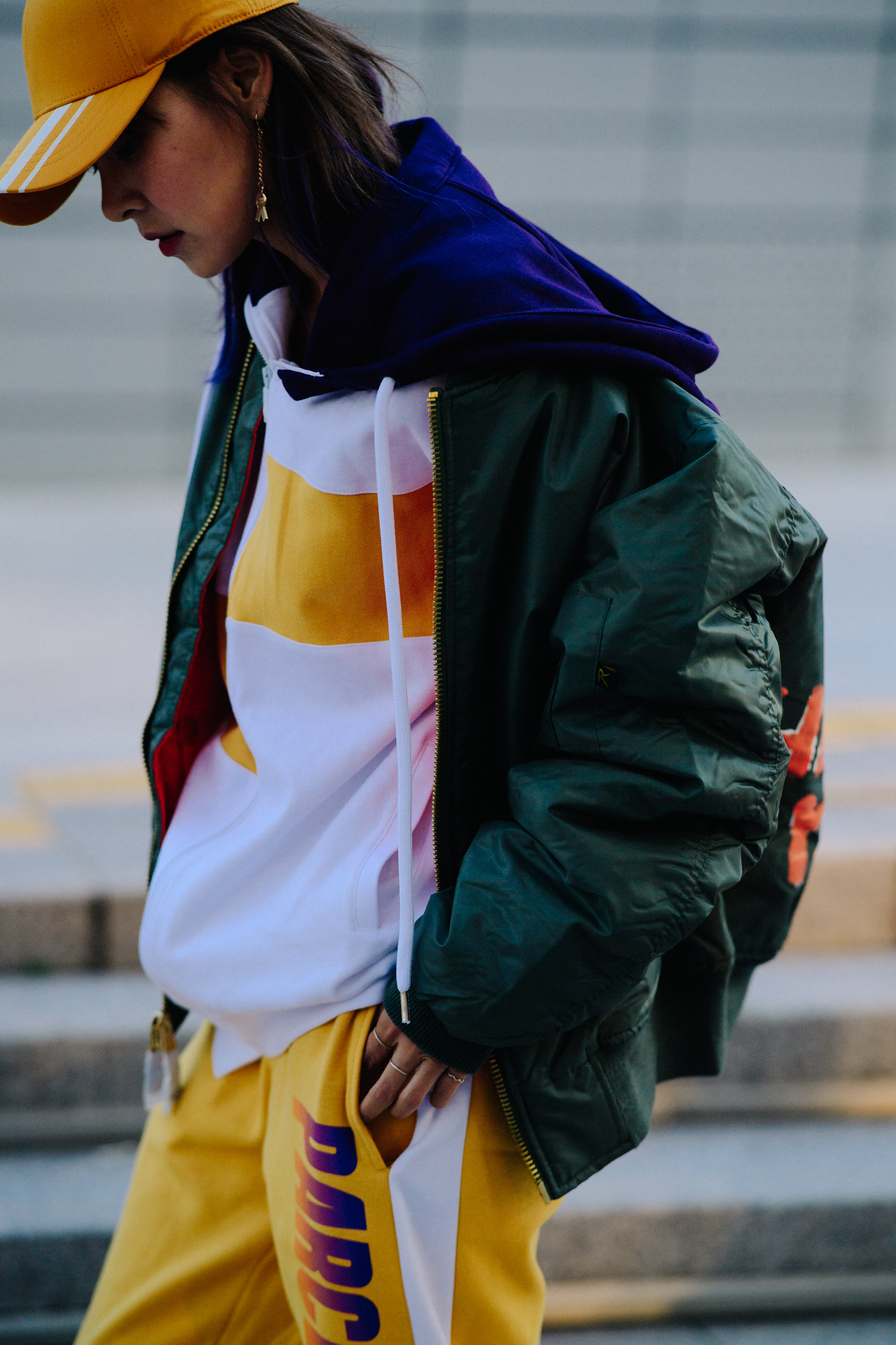 Crop of woman in green bomber jacket
