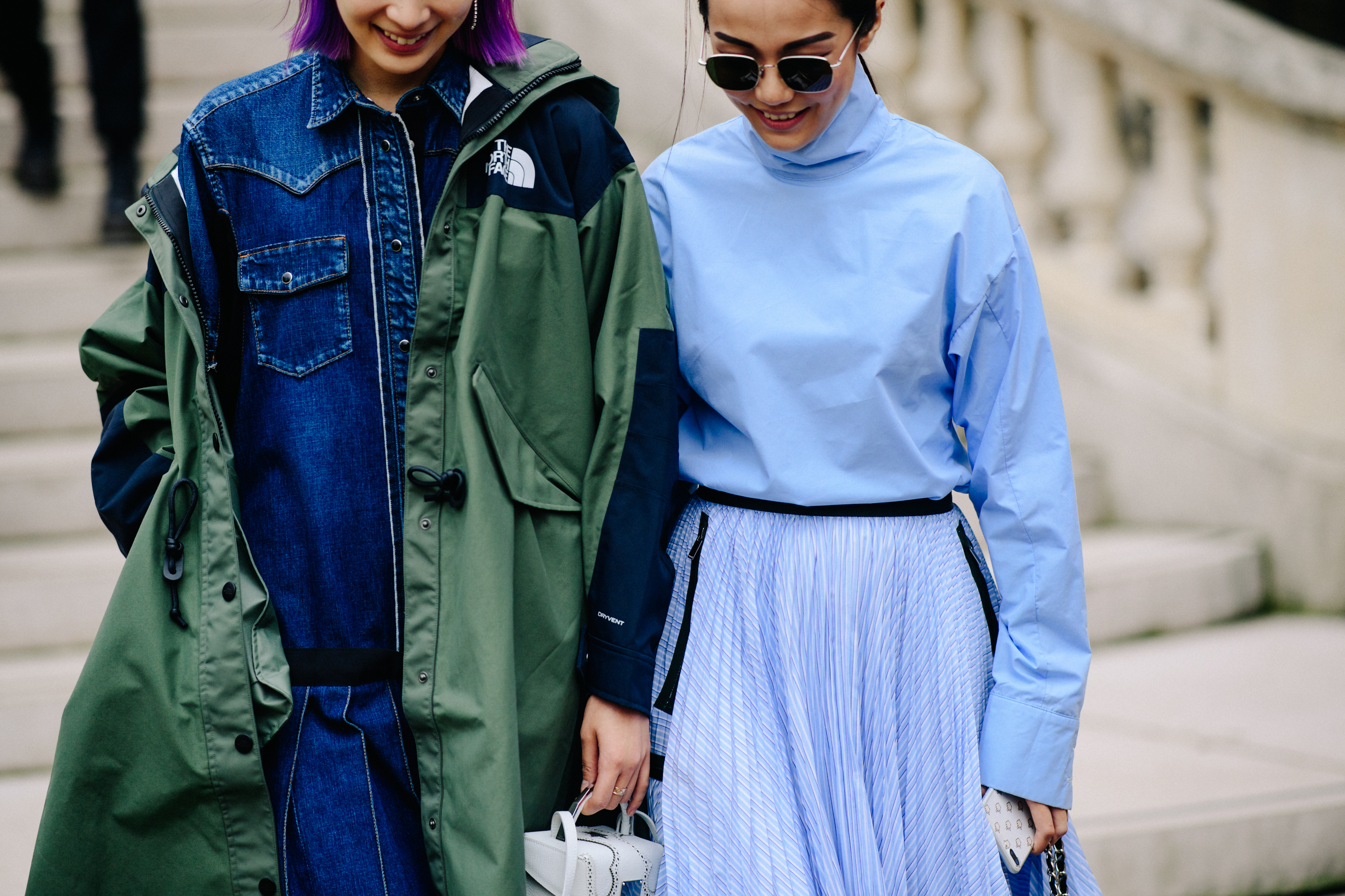 Two women wearing The North Face x Sacai