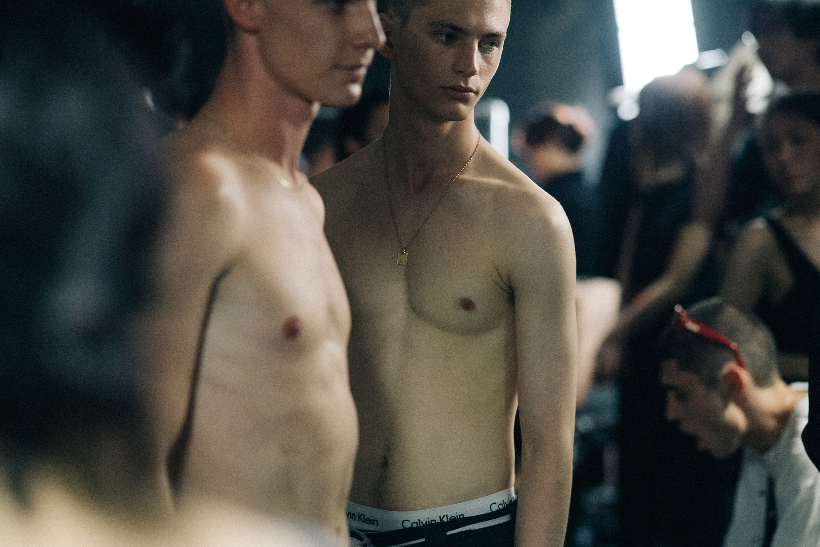 Two male models posing backstage