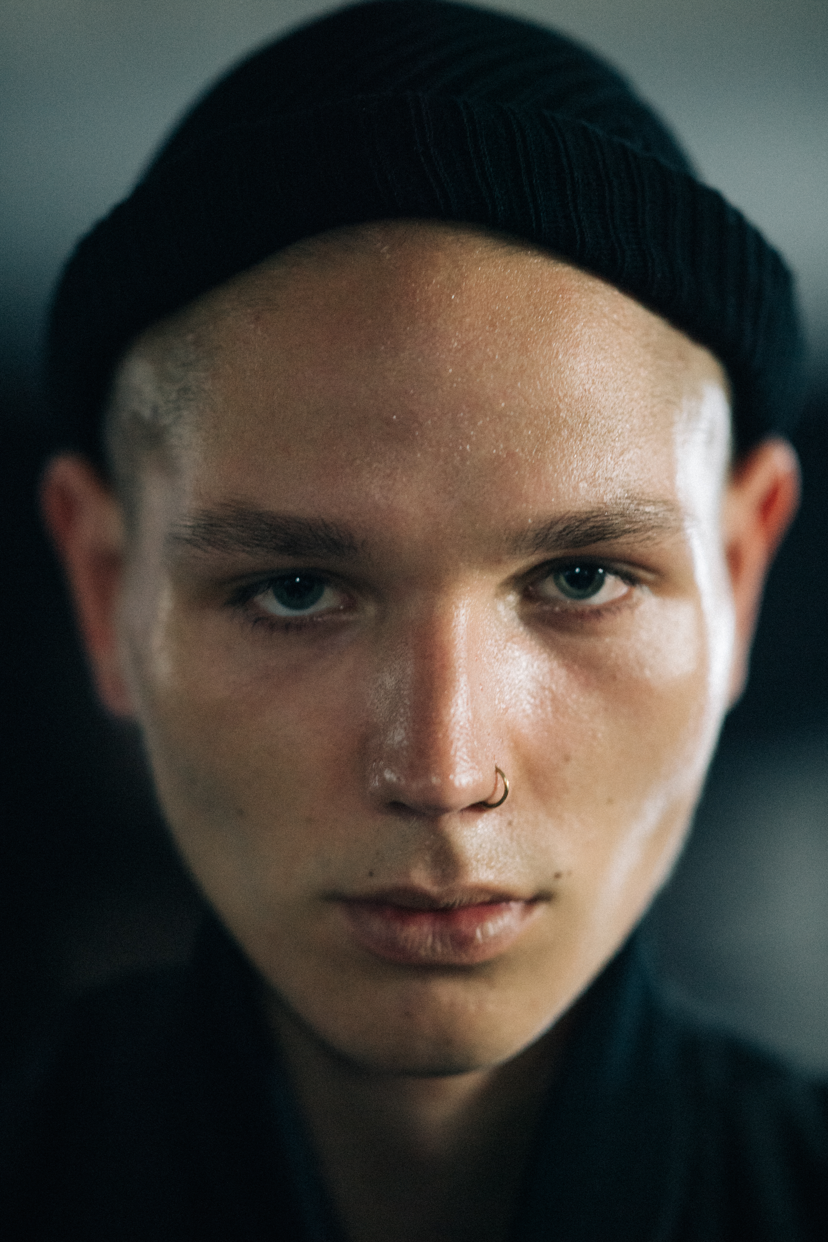 Portrait of model with nose ring and black beanie