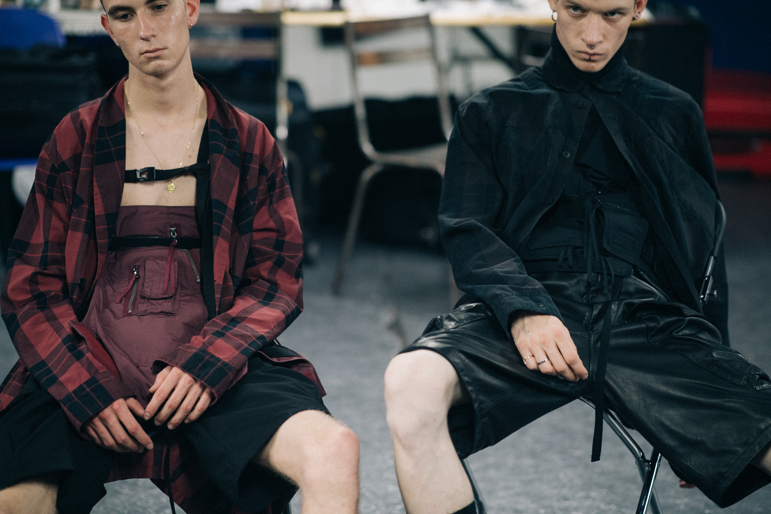 Two models sat backstage