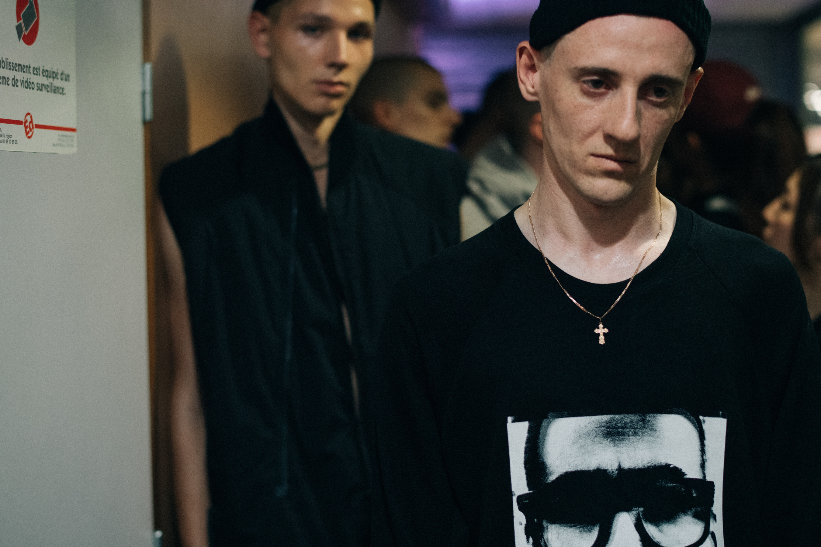 Model wearing gold cross necklace