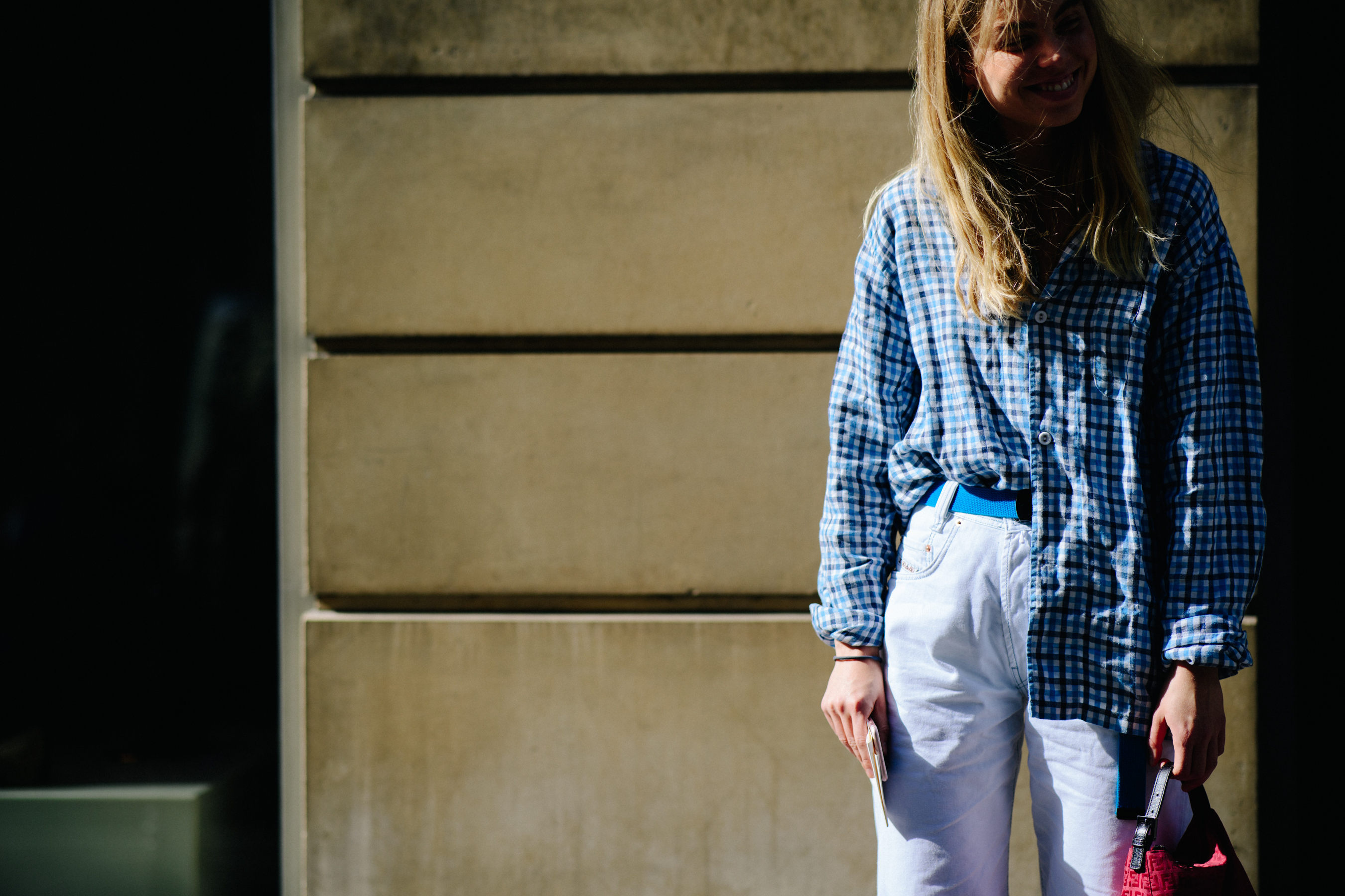 Woman wearing blue shirt and white pants