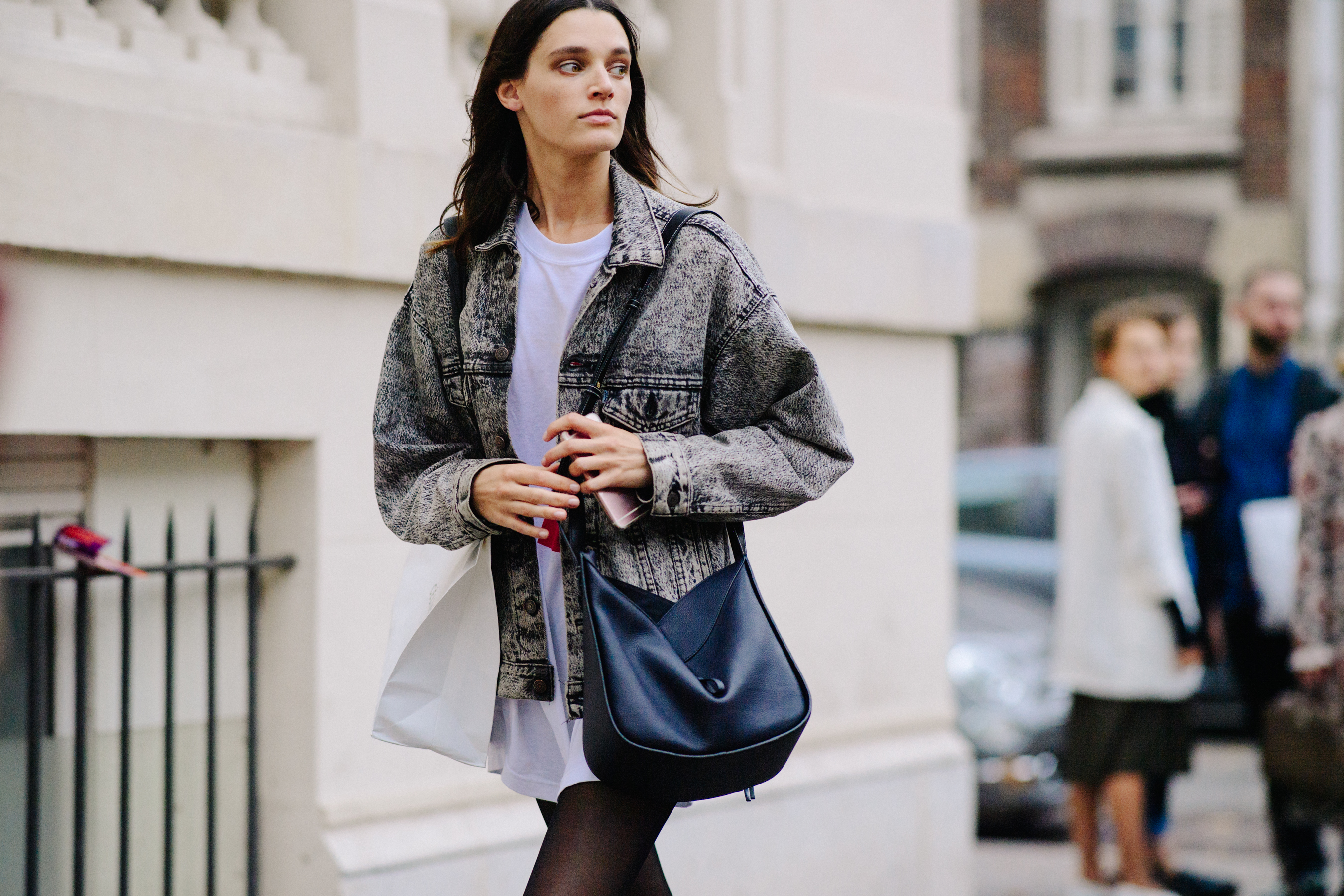Model wearing black bag and denim jacket
