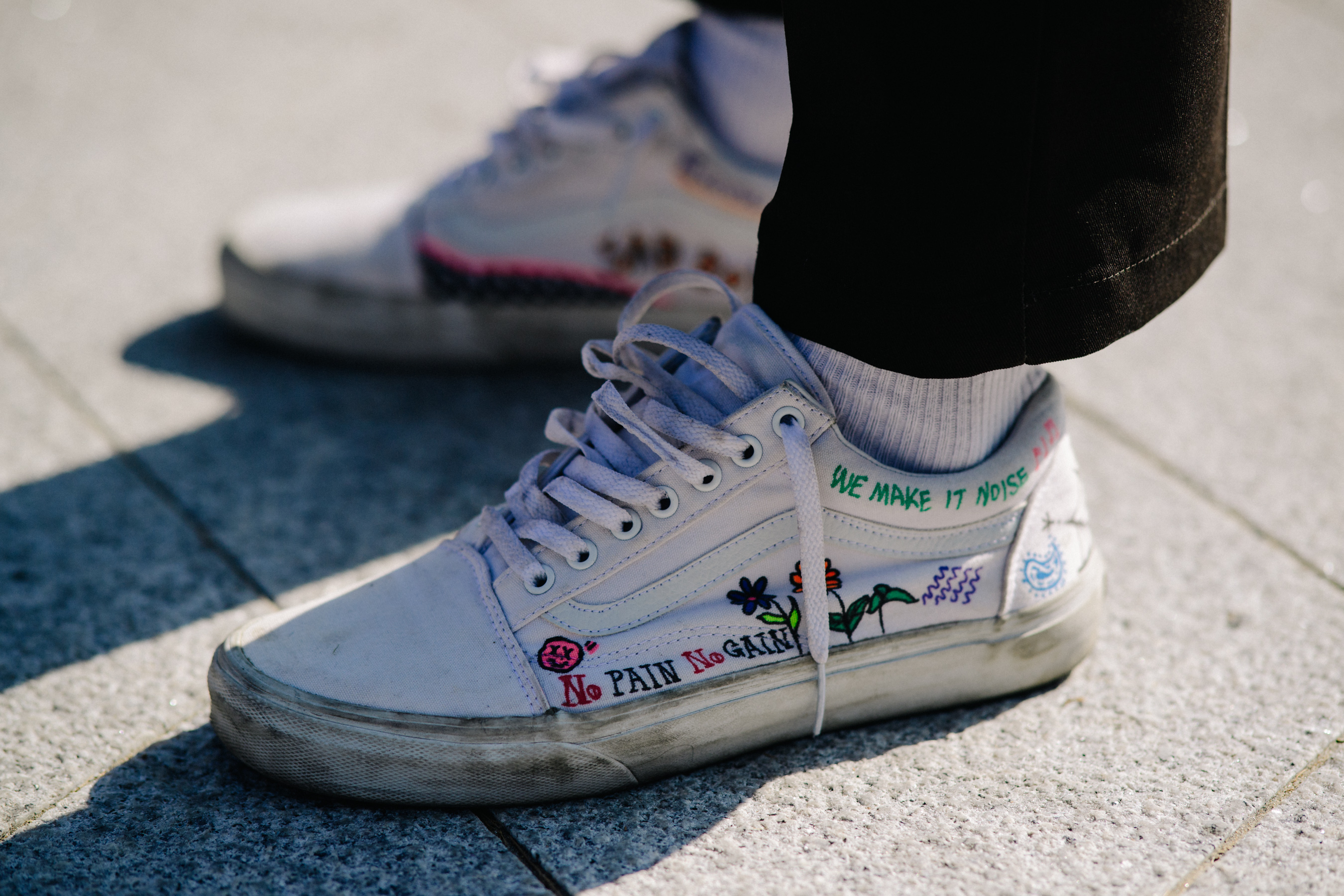 Closeup of models customised Vans shoes