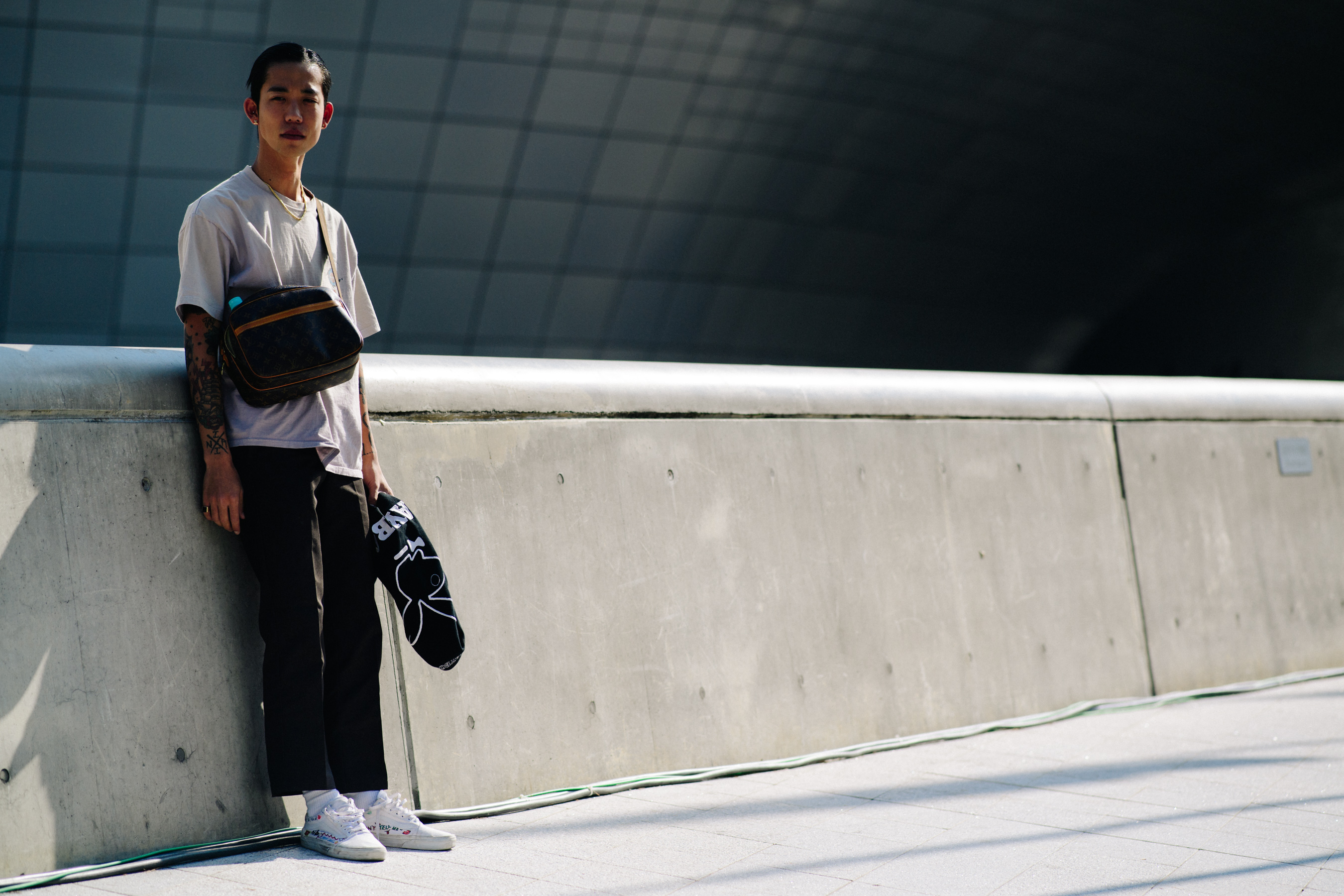 Asian model with brown leather satchel