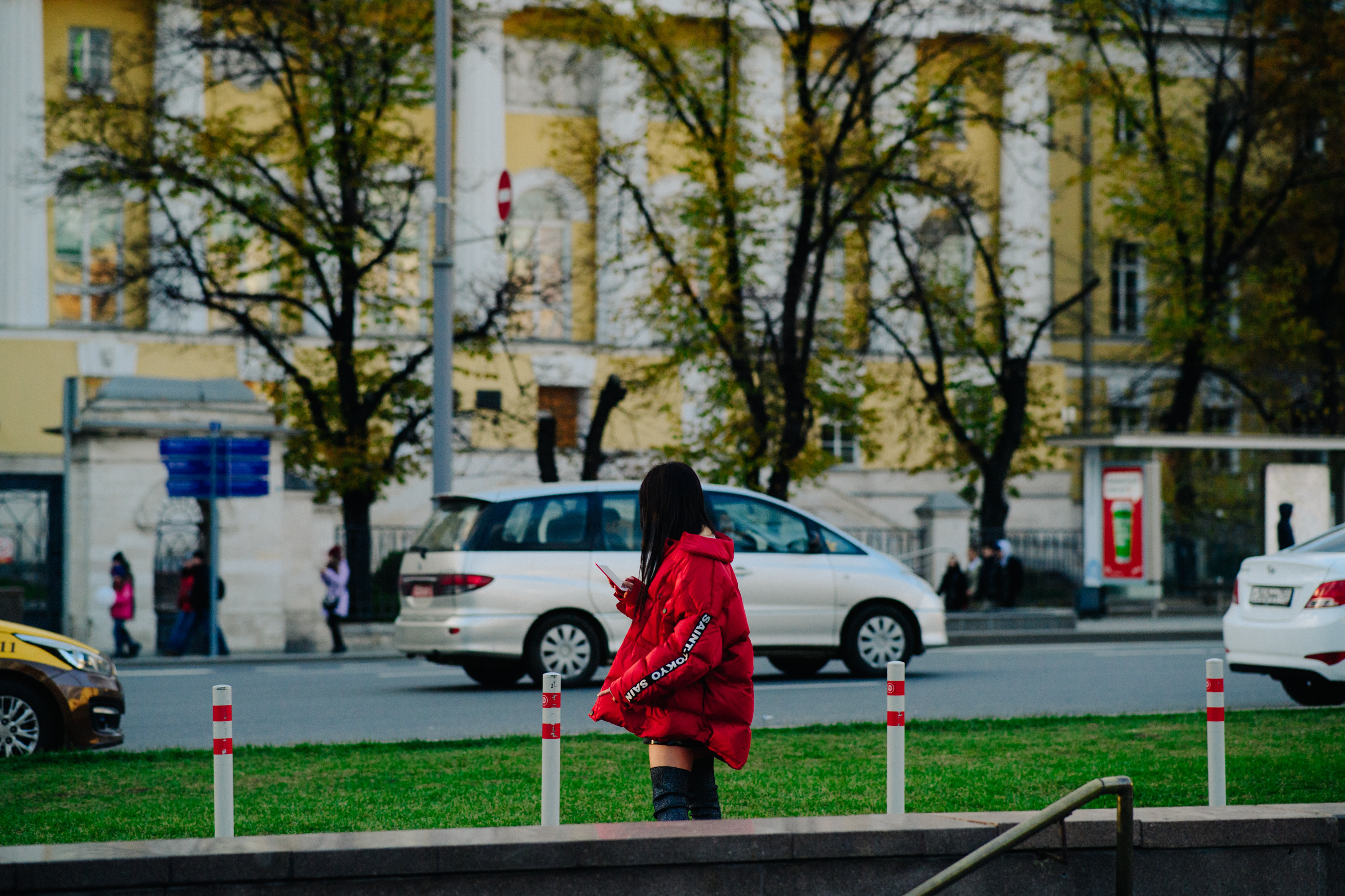 Woman on phone wearing red puffer coat