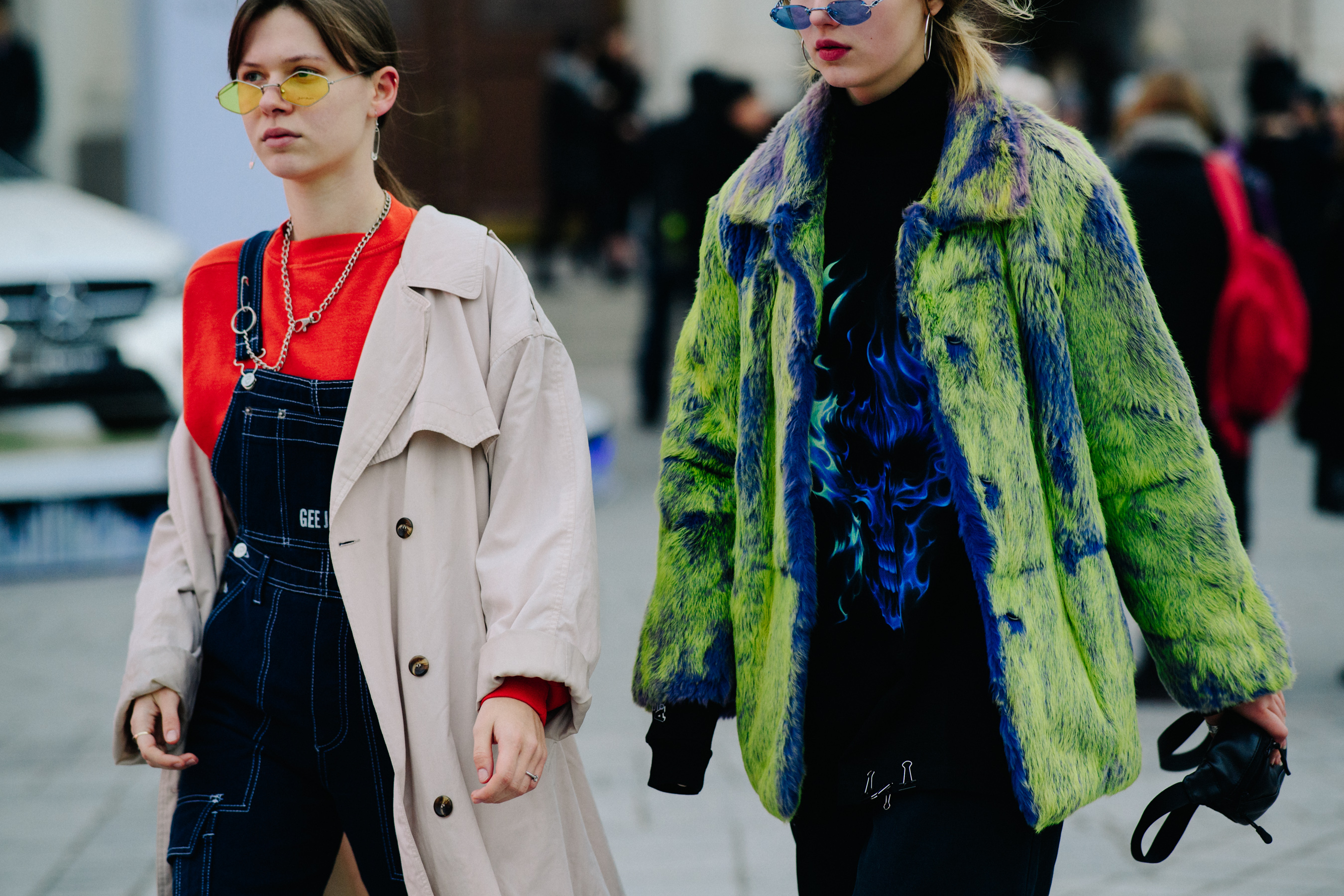 Two women wearing angular glasses and colourful outfits
