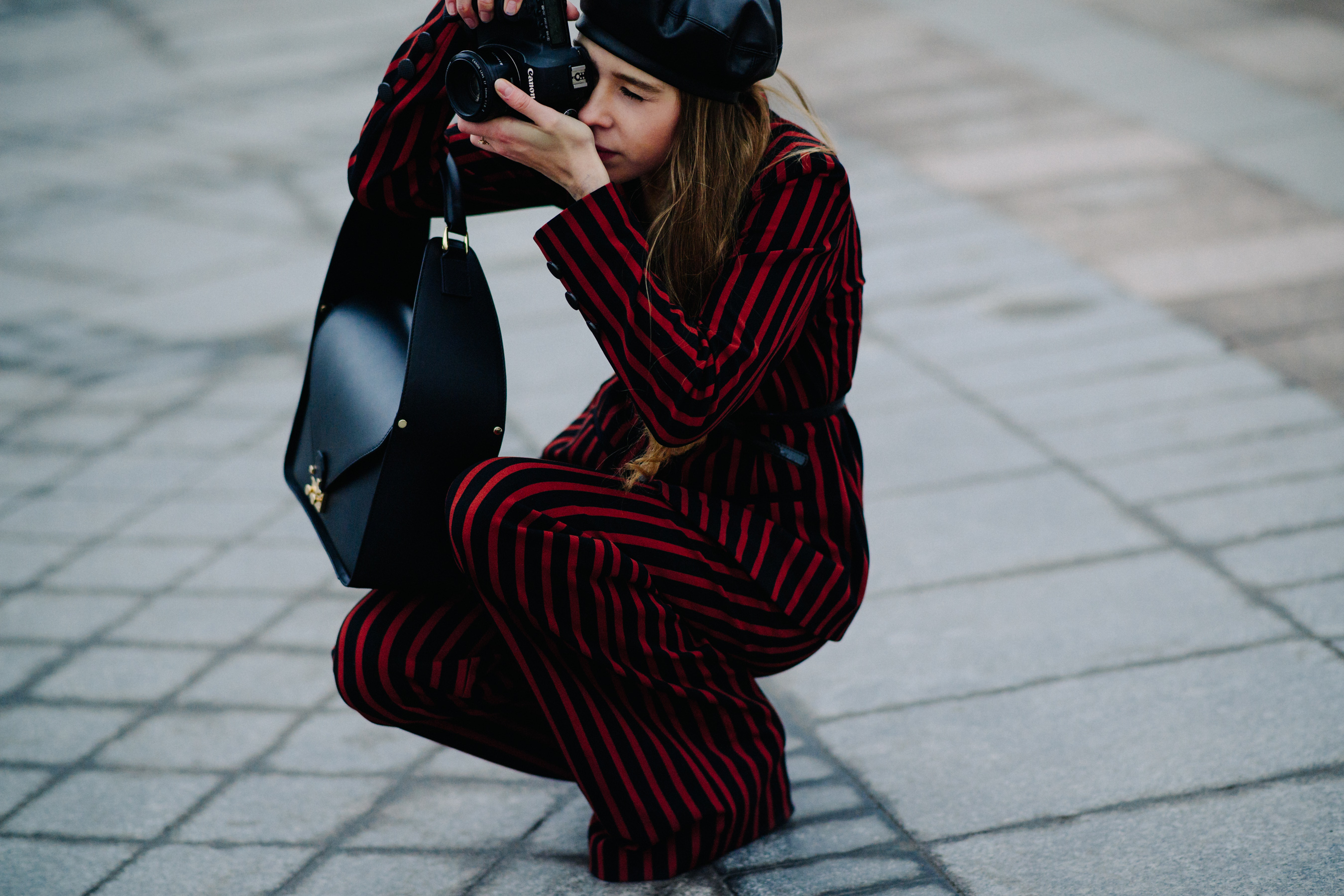 Woman crouched in striped suit