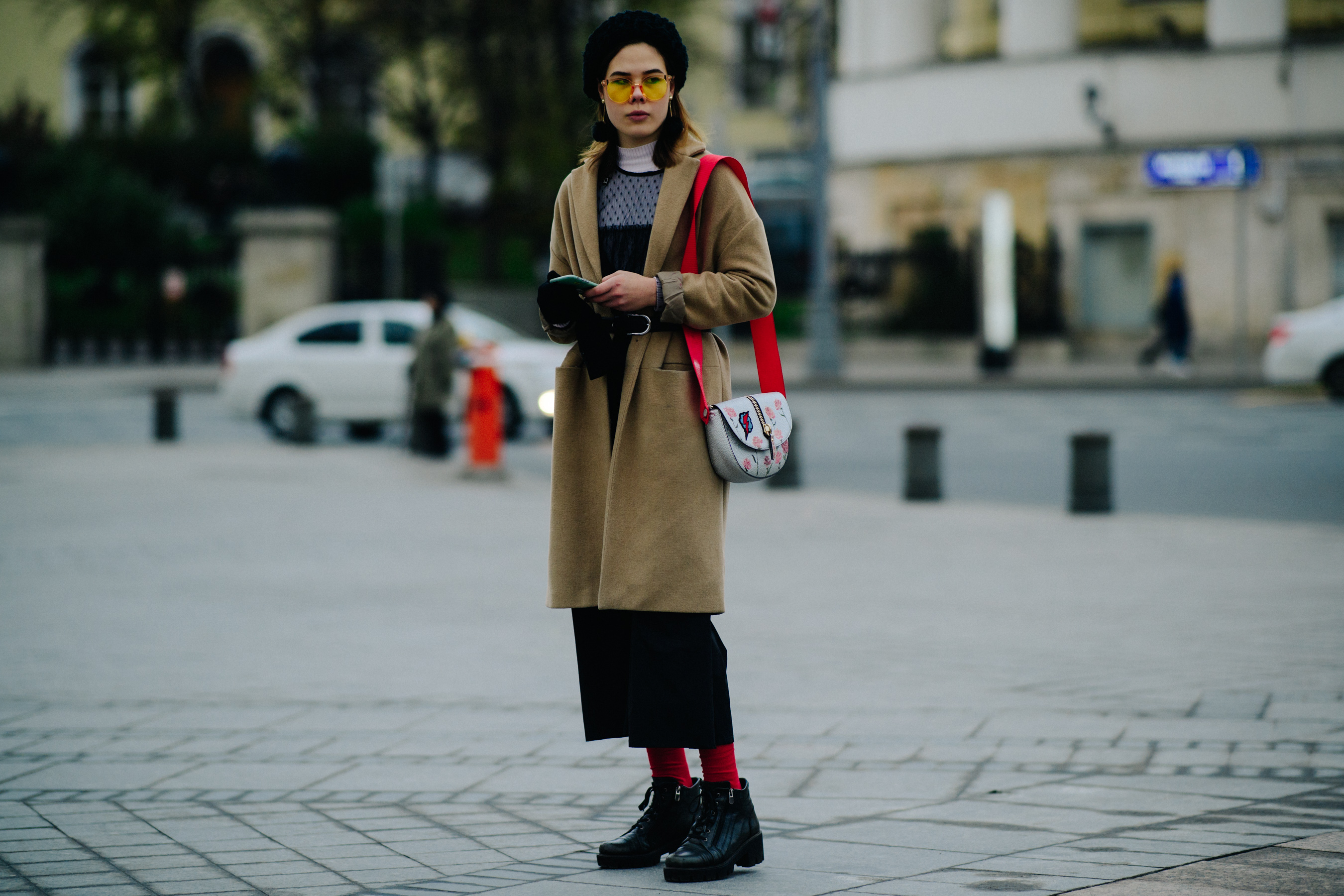 Woman with red strap handbag