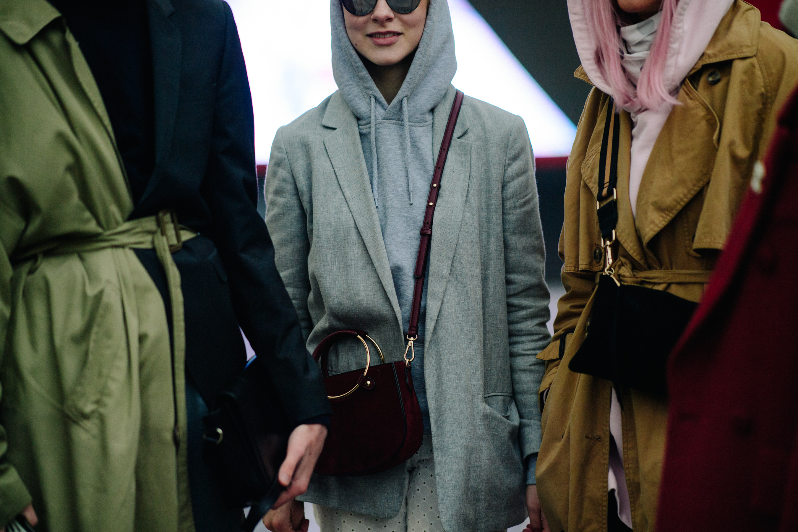 Woman in grey hoodie and coat