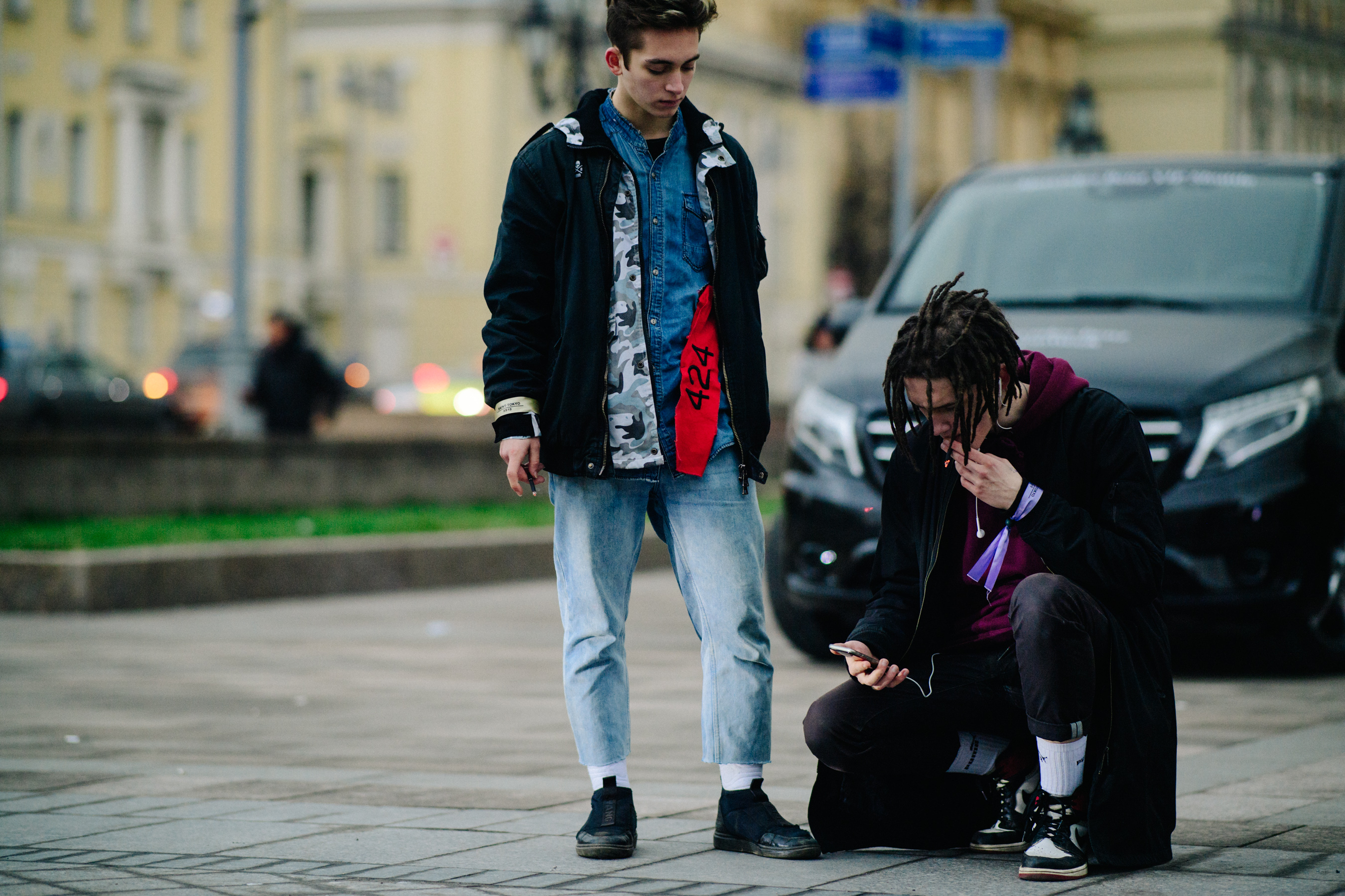 Two men smoking outside