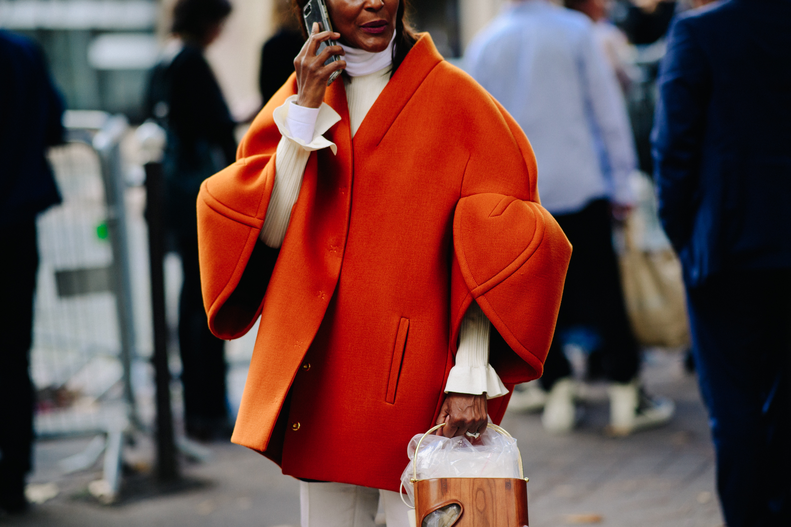 Woman wearing big orange coat