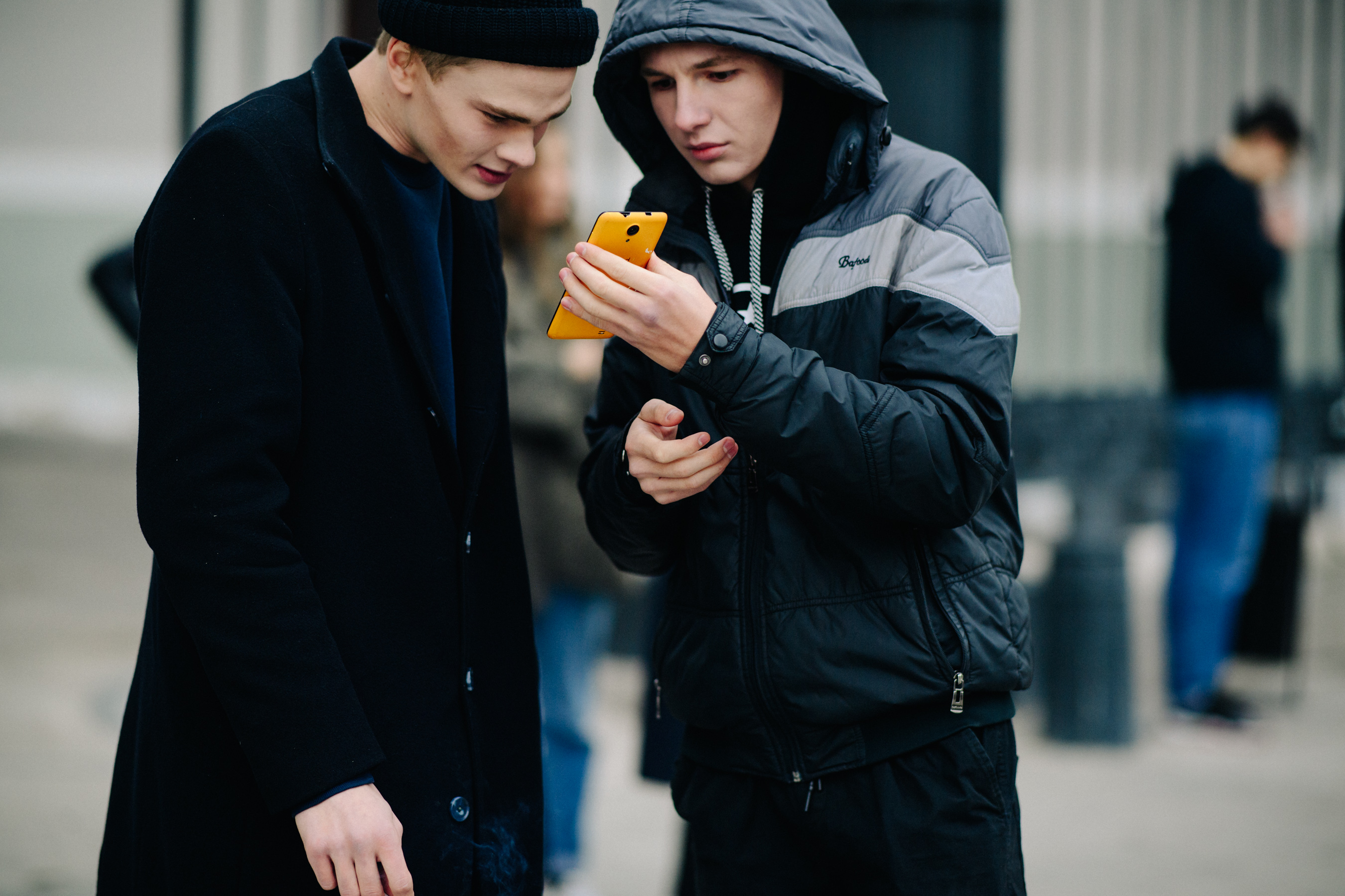 Two men looking at phone