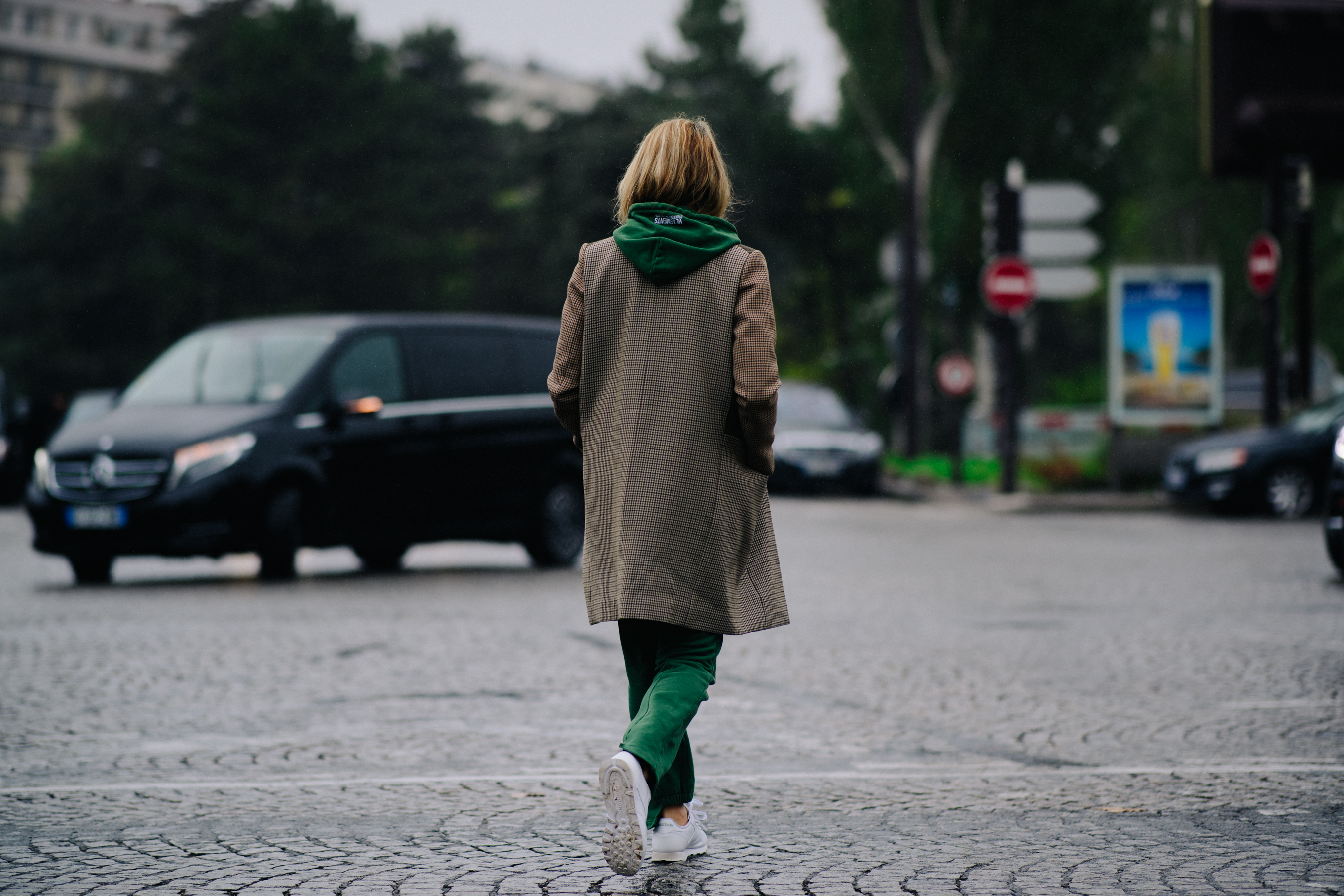 Woman wearing green Vetements hoodie