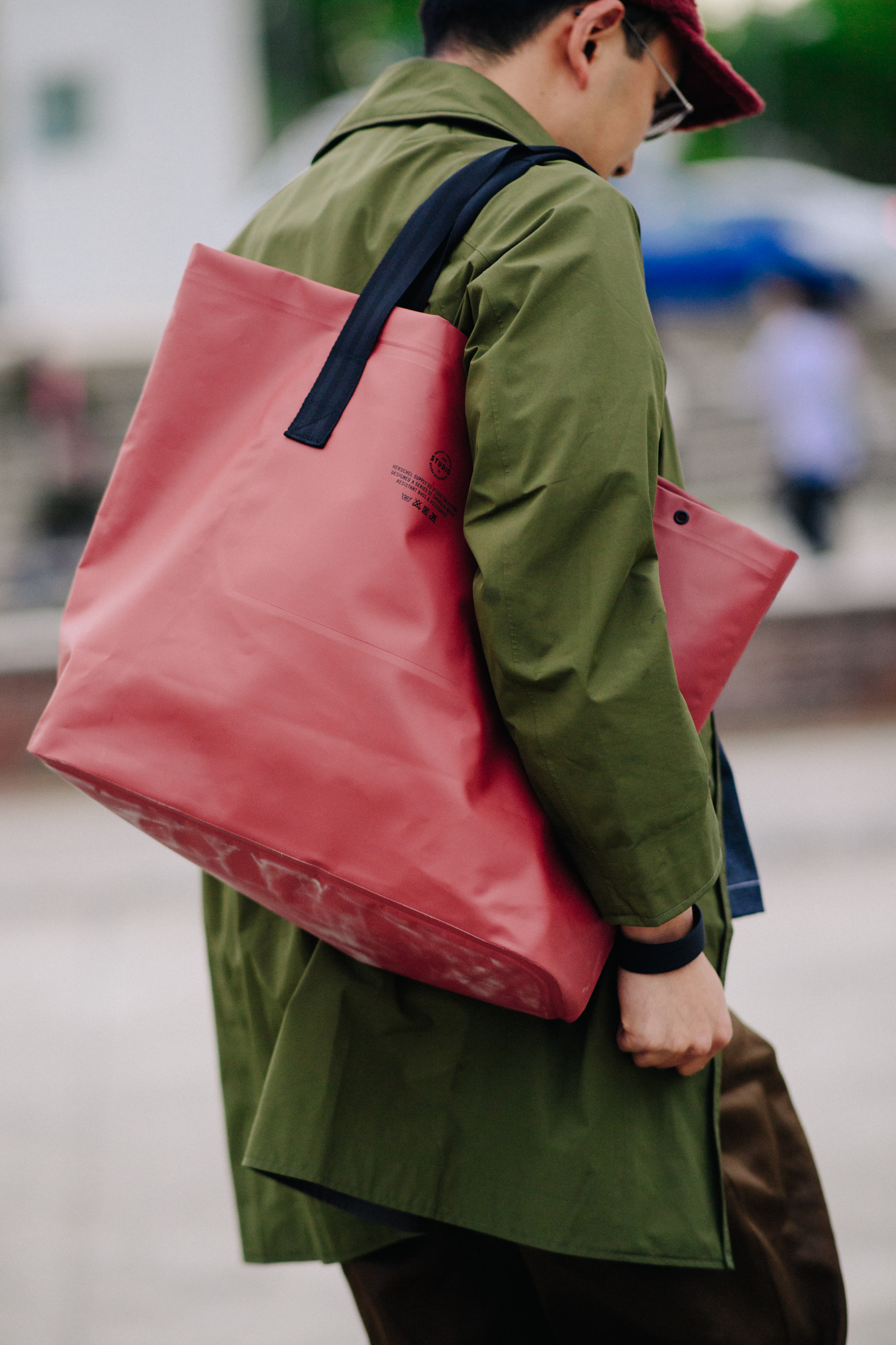 Back of man with red bag and red cap