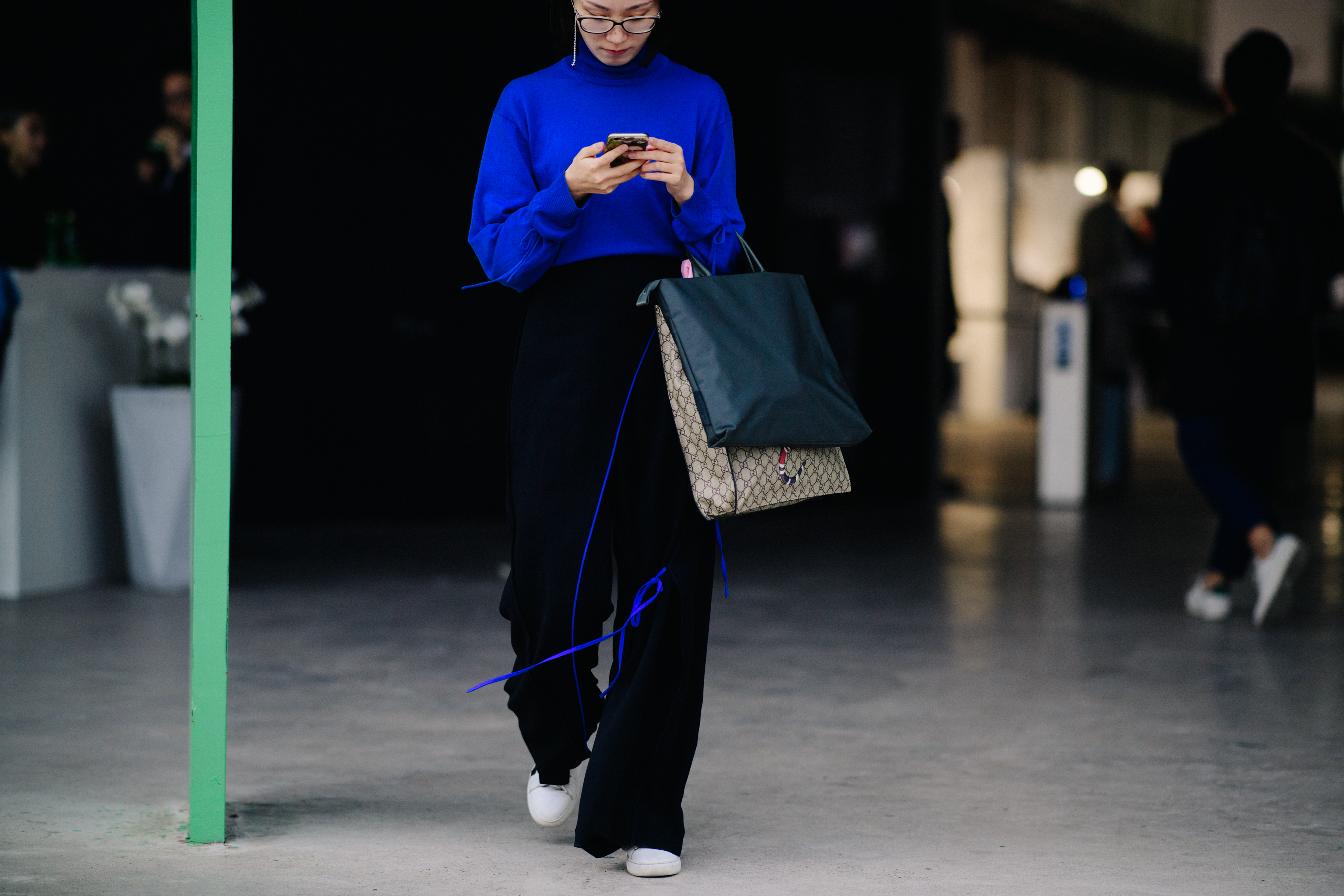 Woman wearing blue shirt with long tassels