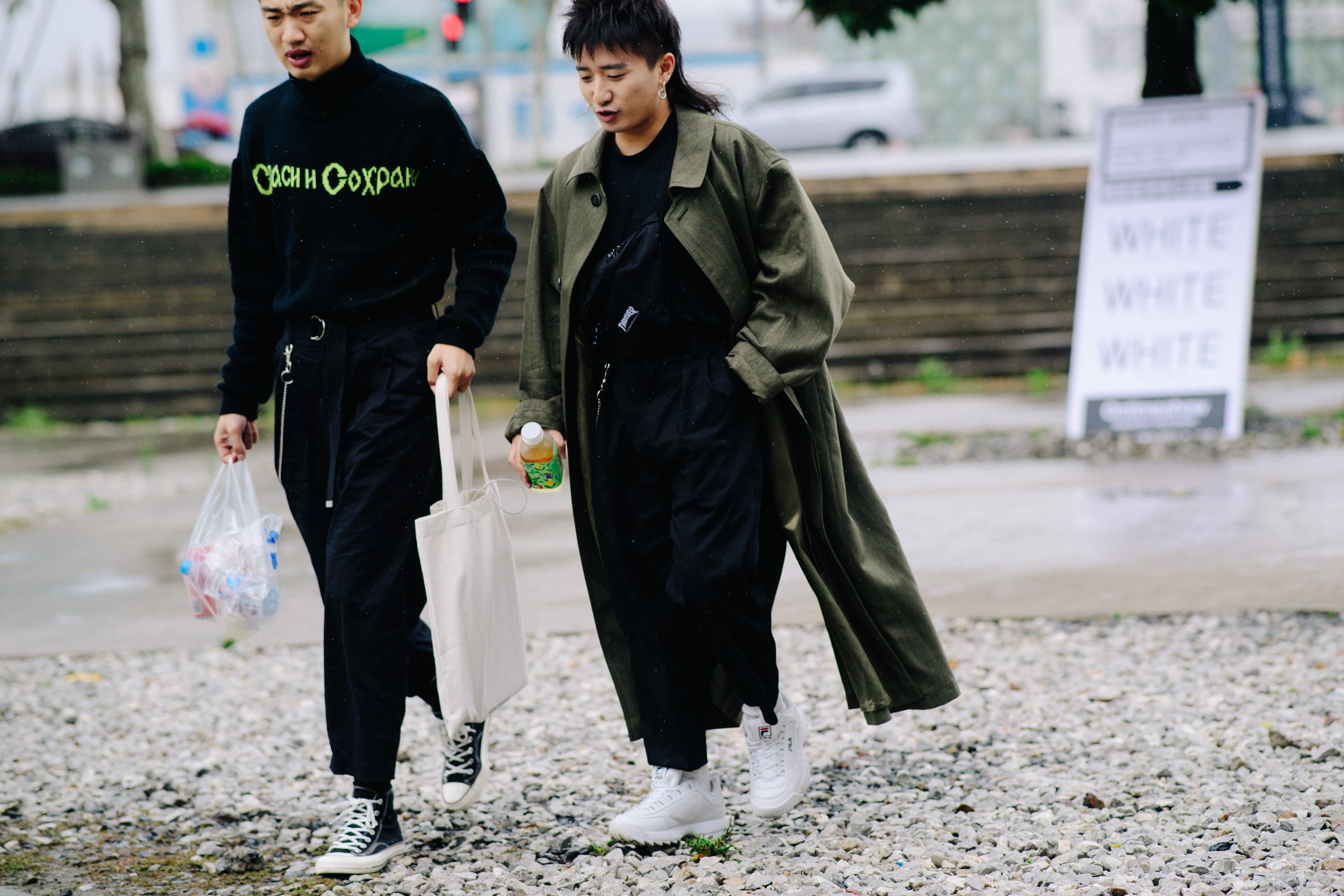 Two men walking in black outfits
