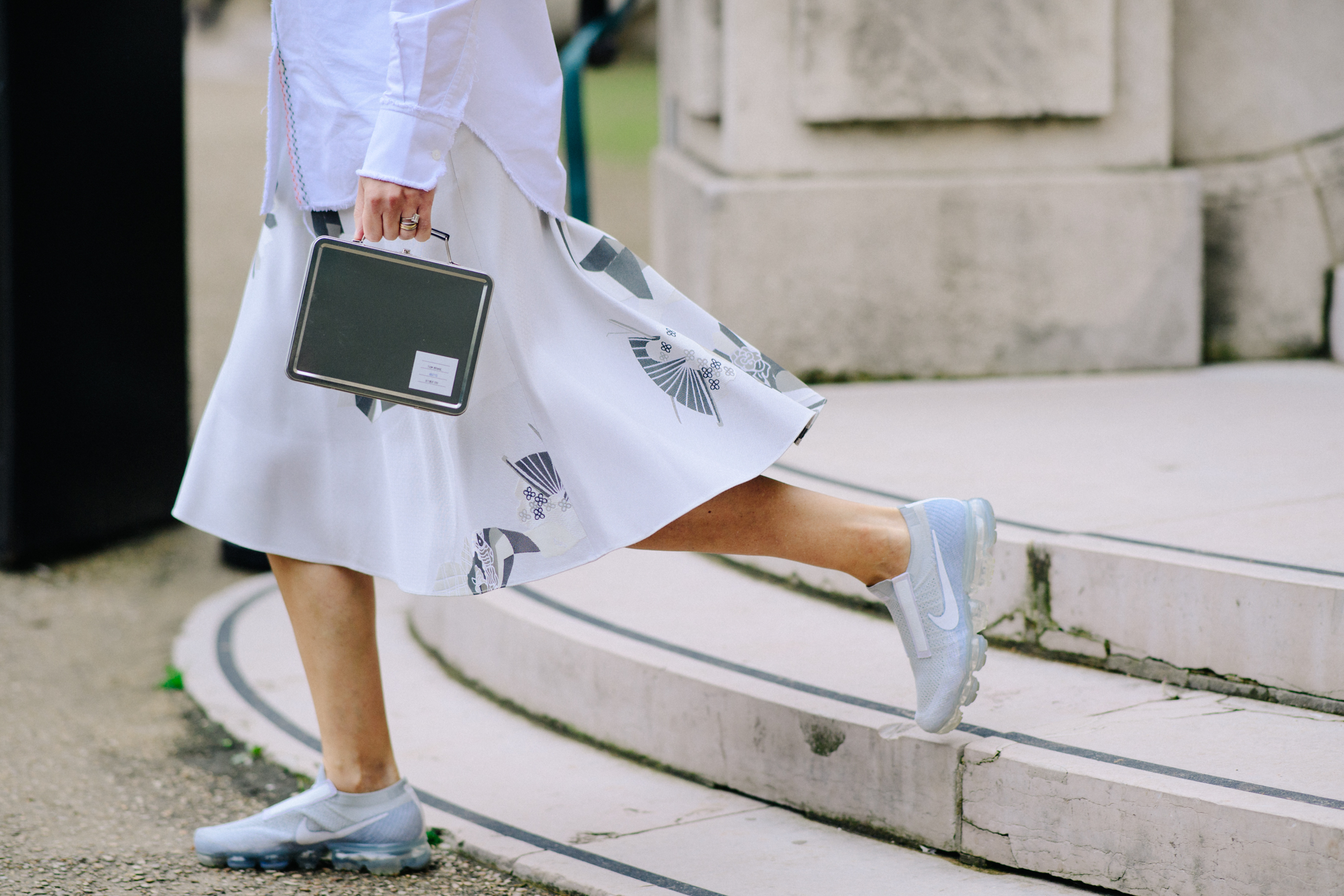 Woman wearing white Vapor Max sneakers