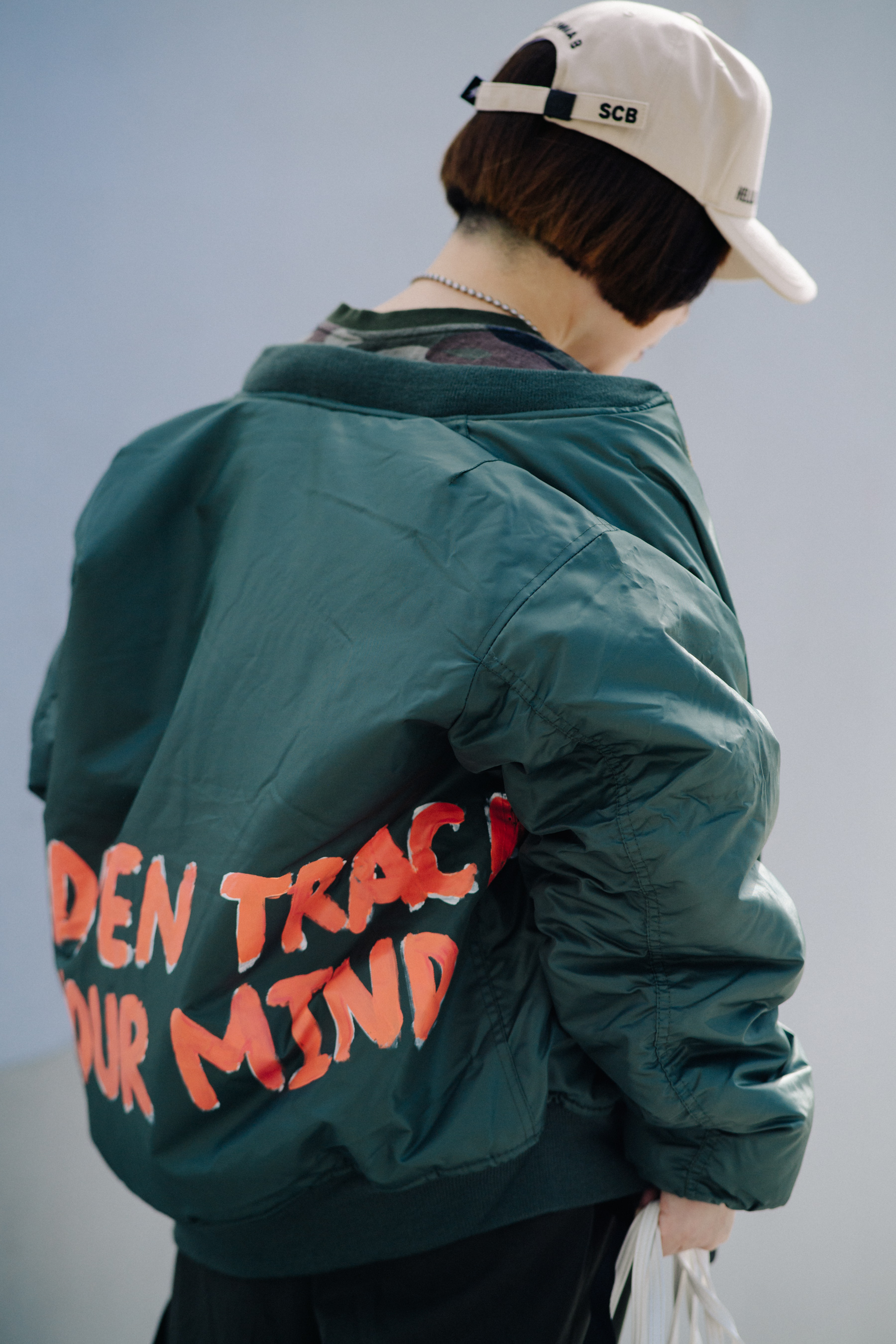 Woman wearing green bomber jacket
