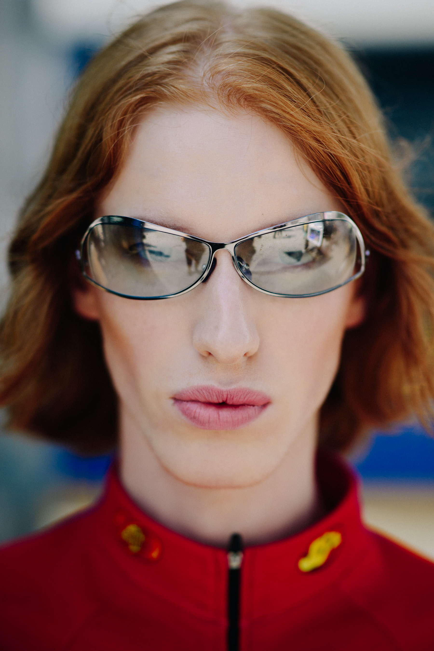 Porrait of model with silver sunglasses and ginger hair