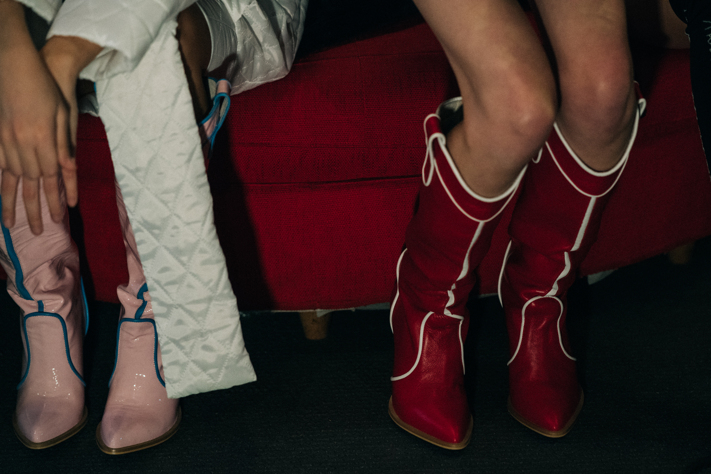 Models wearing pink and red boots