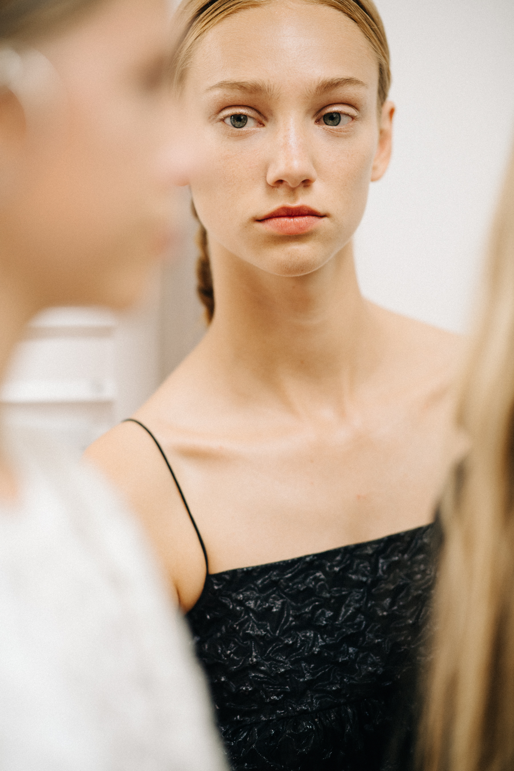 Model with blonde wearing black dress