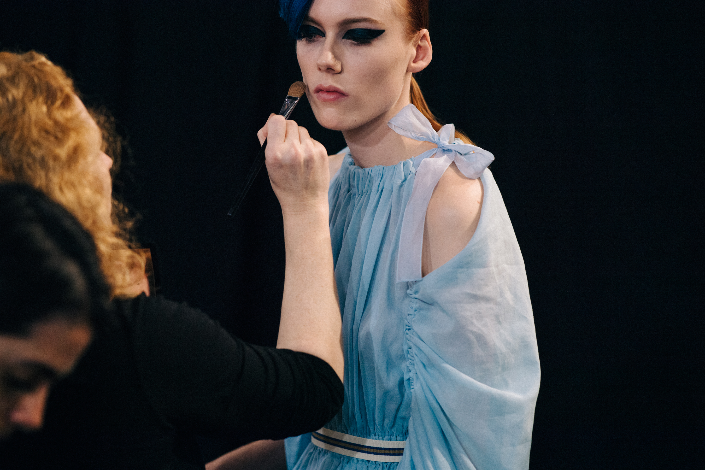 Model having makeup touched up backstage