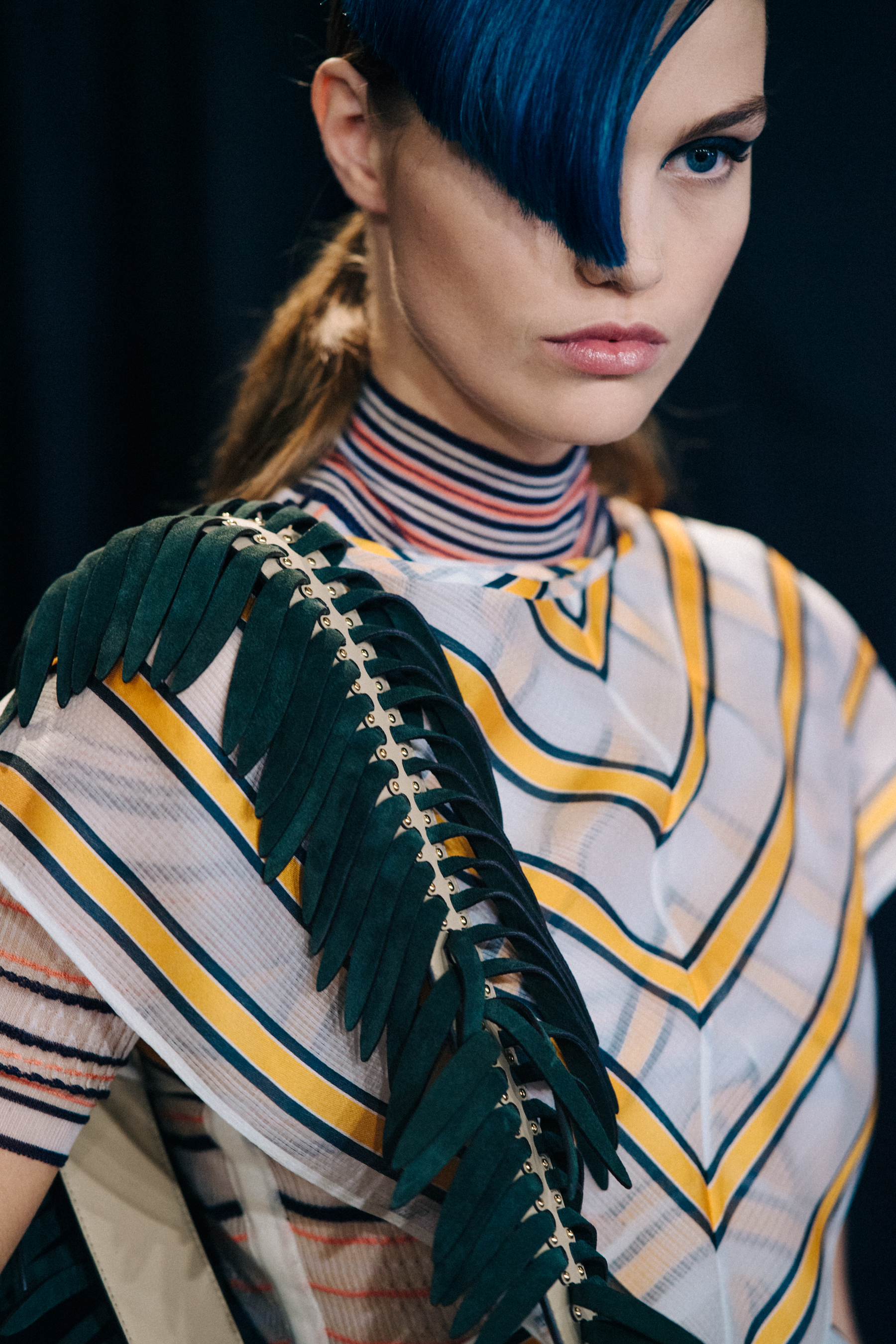 Closeup of Dutch model with blue fringe and striped Fendi top