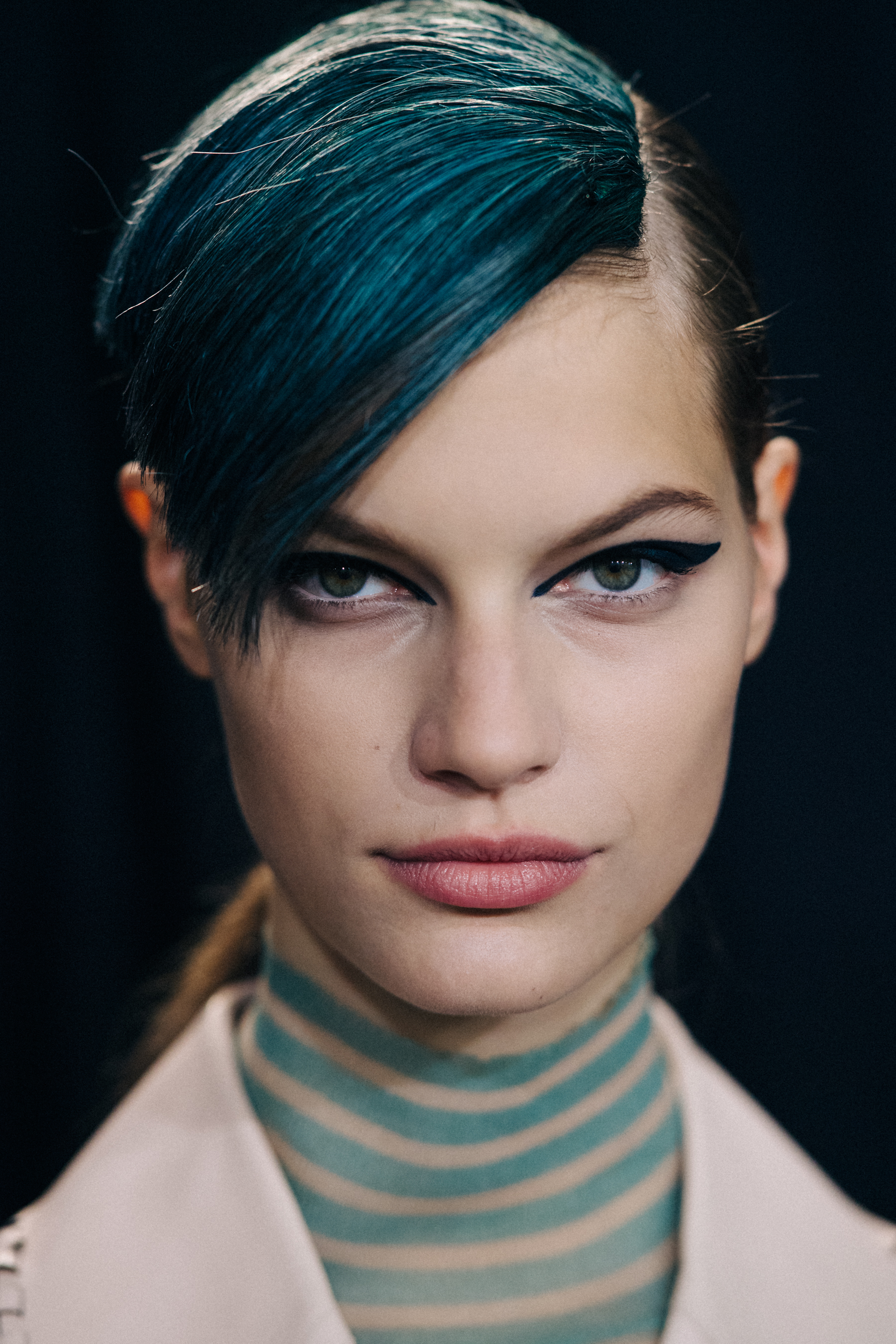 Portrait of Model with green eyes and blue fringe