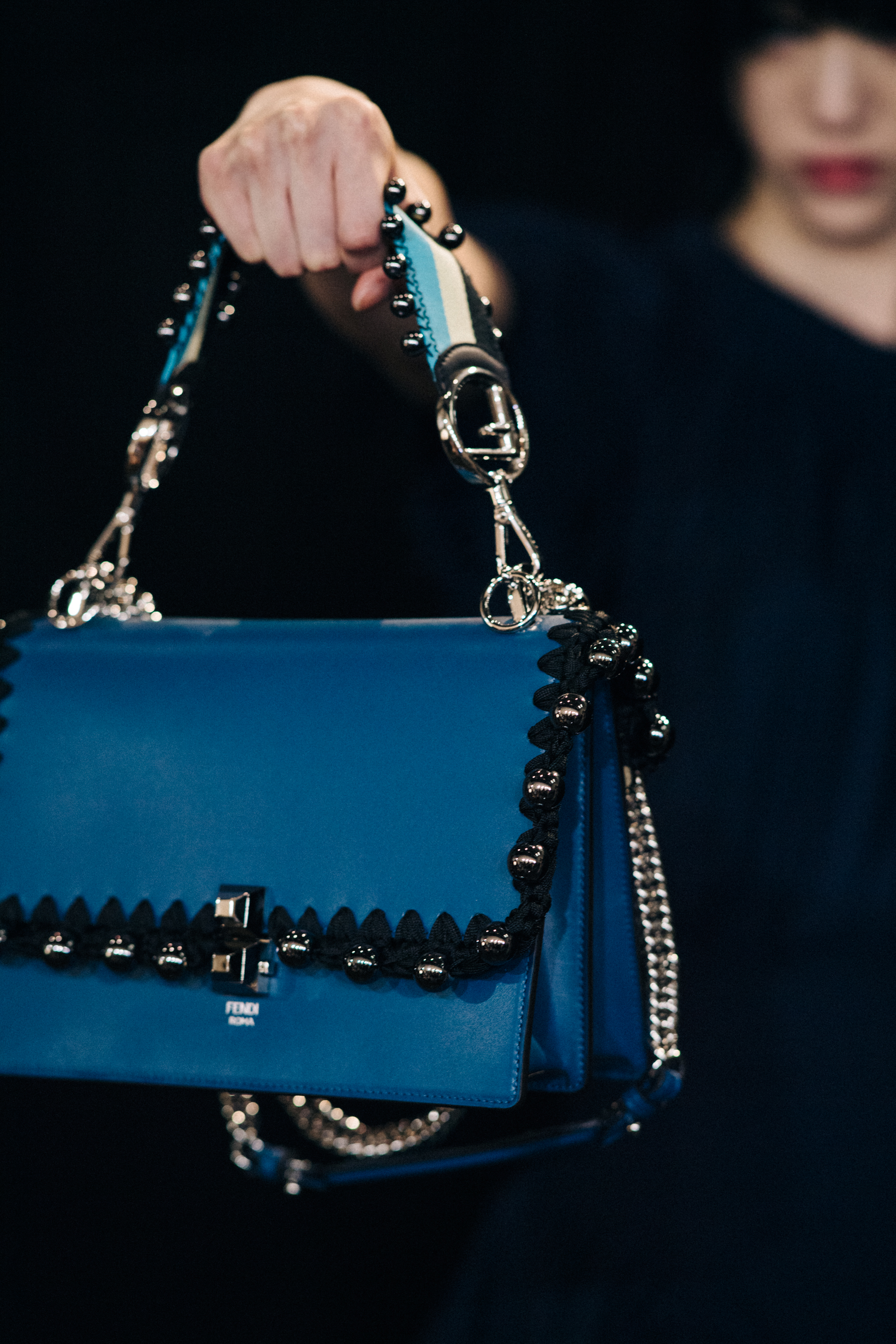 Closeup of Fendi handbag held by model
