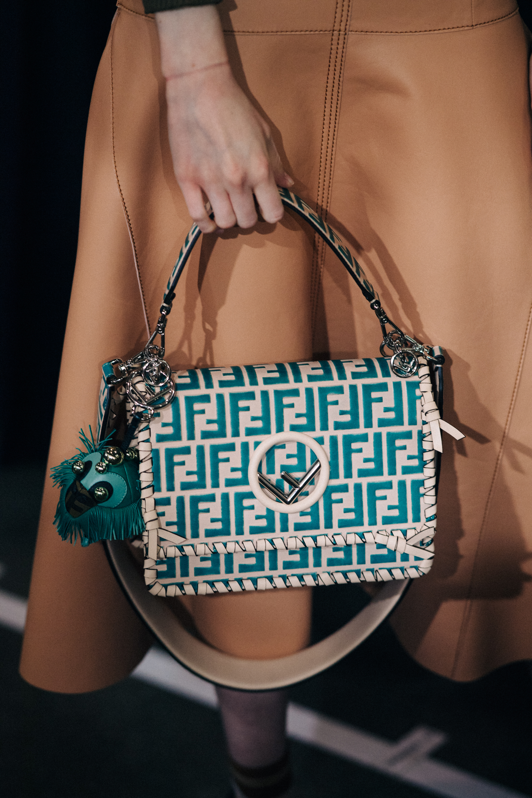 Model holding handbag backstage