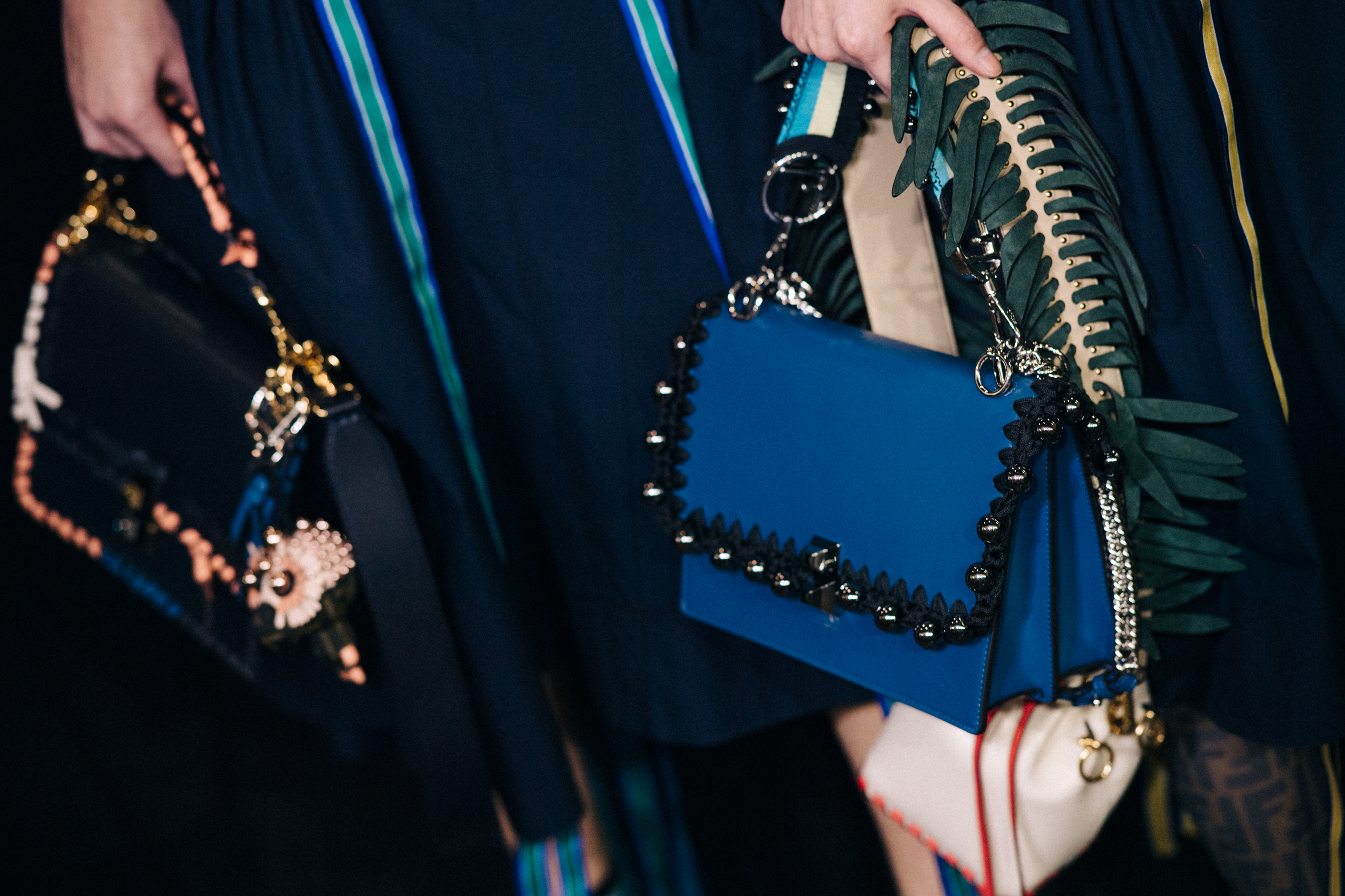 Models holding Fendi bags backstage